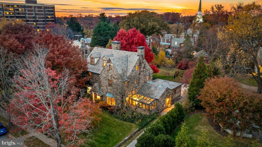 Happy holidays from 6 E. Highfield! This special home has been in the same family for nearly 100 years and is finally making its debut to find new residents to cherish it for the next 100. This 1920s all-stone house has the great old bones only found in early 1900s built houses. It's adorned with irreplicable historic details that will satisfy the wants of any architectural purist, yet it boasts an amazingly functional floorplan that lends itself to anyone looking to enhance it with more modern finishes. With an effortless flow and well-proportioned room sizes, there are 5-6 bedrooms, 3.5+ bathrooms, approximately 3,750 sqft above grade, and an additional 1,860 below, making it roughly 5,600 sqft in total. There are 6 fireplaces, each unique in detail, staggered wide plank hardwood floors, and handsome moldings throughout. The kitchen is extremely cool, with ample cabinetry and a large center island that opens to a solarium with walls and ceilings of glass. You’ll find yourself with a consistent topic of conversation when hosting. Directly off the kitchen is a bonus room that would make a perfect combination of a butler's pantry and mudroom. The formal living room and dining rooms are beautiful traditional spaces, each with bay windows and wood burning fireplaces. There is also additional space behind the living room that would make a great home office. The lot is amazing - .35 flat, open acres, mostly fenced, providing the perfect setting for summers full of children’s laughter, lively barbecues with friends, beautiful gardens, and tranquil dinners under the night sky. For anyone looking to add a pool, rejoice - there’s room for one here! To enhance the outdoors even more, there is a flagstone patio, a pond, a charming covered porch with electricity, and incredible specimen trees scattered about. There is also a convenient 2-car garage attached to the rear of the home. Travel back inside to the 2nd floor, and you'll find two ample-sized bedrooms and a full bathroom, as well as a large primary suite. The primary suite is oversized with an updated en-suite bathroom, dual closets, and a fireplace. The 3rd floor of the home has two additional bedrooms, another full bathroom, and a large storage room that could be easily converted into a 6th bedroom. The basement is currently partially finished but has tremendous potential if you find yourself needing more living space. It's 1,800 sqft with tall ceilings, a partially finished bathroom, and most of the basement has been waterproofed . There is also a one-of-a-kind antique bar that was salvaged from a restaurant in Fells Point long ago. You’ll be hard-pressed to find a more amenable house than this in Guilford at this price point. It offers a wide variety of options, whether you’re an architectural purist who wants to lean into the rich historic details that exist or someone who wants to upgrade and enhance what already exists by adding more modern finishes, the house fits either perspective. In addition to all that, this home uniquely falls into the Roland Park Elementary-Middle School district and is also walkable to Calvert School, ensuring excellent schooling options for families. Guilford is the perfect neighborhood for anyone looking for a detached home with a yard but who doesn’t want to give up the social amenities offered by city living. In Guilford, you can find the space and privacy you need, but you’ll still have neighbors to spend time with, restaurants to walk to, museums to visit, and parks to convene in. Additionally, the HOA will keep you engaged with neighborhood events and parties throughout the year. Guilford is also located centrally between downtown Baltimore and Baltimore County, making commuting to either convenient. It’s also minutes from major employers like Johns Hopkins, Loyola, and Union Memorial. This is your opportunity to secure this special Guilford house as your family's beloved holiday home for years to come. Don't miss it!