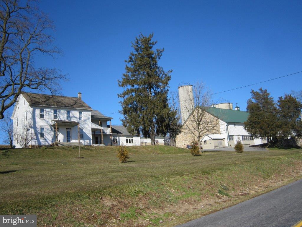 Country 14 acre Farmette. 2 1/2 story, 6 bedroom farmhouse with 3,860 Sq. ft. Large country kitchen. 48x100 bank barn. 22x126 garage/shop building with 8 car garage spaces. Tenant rental separate 1 Bdrm unit. Large RV Rental Storage building. 44x325' with 23 separate rental units. Current $4,400 per month income. Half Bath in RV building. . Absolutely "one of a kind" farmette with rental income. Majority of mtg and taxes paid by rental income.
