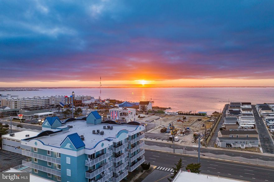 Discover the epitome of luxury coastal living in this authentic 5-bedroom oceanside residence. Immerse yourself in the charm of this two-story condo, boasting dual entrances, one on each floor for added convenience. The expansive balconies gracefully wrap around the entire Western to Southern side, providing breathtaking panoramic views and are perfect for catching sunsets & Fourth of July fireworks display.

Ideal for a family retreat, this meticulously designed home accommodates 12-16 guests comfortably. Unwind in two spacious master bedrooms, conveniently located on separate floors. With 5 full bathrooms (4 ensuites & 1 shared/Hall), ample space and privacy are ensured for everyone.

Ensuring a perfect blend of comfort and entertainment, relish in the expansive family room featuring a fireplace and unparalleled vistas. Need to cool off after a day at the beach? Take a dip in the inviting pool. Worried about parking? Fear not, as this residence offers 4 covered parking spaces. The entrance to the building & elevator are secure with a coded entryway.

Strategically situated just a block away from Ocean Pines Beach Club, revel in the tranquility of a wide and non-crowded beach, making it the perfect seaside escape. Just a short stroll to Seacrets, Macky's, Dumser's Dairyland, mini-golf and water sport rentals.  This home is rental-ready, and for a detailed overview of its successful history, contact the listing agent. Elevate your lifestyle and schedule a tour to experience the coastal elegance of this remarkable property.