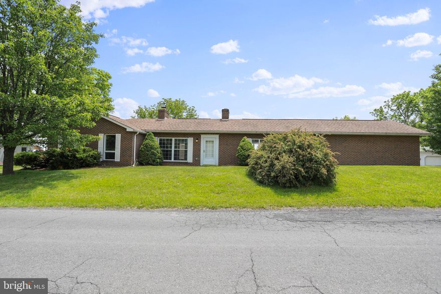 Welcome to your dream home nestled in the serene countryside of West Virginia! Located on a quiet tree-lined country road, this single level brick rancher offers three-bedrooms and two full baths throughout the sprawling 2,332 square foot home.  A solid brick rancher, this home exudes timeless appeal. A two-car attached garage ensures convenient parking, while a bonus 2-car oversized detached garage provides ample space for all your toys, tractors, and even a workshop area. The possibilities are truly endless for pursuing your hobbies and indulging in your passions. Step inside to discover the architectural masterpiece that awaits. Two twin in-line brick fireplaces grace the kitchen and living rooms. The expansive kitchen with solid wood floors, brand new appliances and a stunning brick fireplace offers the open space to create endless memories.  This home has been renovated to perfection. Gorgeous hardwood floors, plush new carpeting, and fresh paint create an ambiance that is both stylish and inviting.  Ultra efficient, featuring a heat pump with central air conditioning ensuring comfort all year round. The master suite, kitchen, and living area beckon you towards the breezeway/patio through double sets of French doors accessible from each room! The seamless flow between indoor and outdoor living spaces allows you to enjoy the indoors as much as the outdoors! Situated on a well-proportioned and level lot spanning just under one acre, this property provides ample space for outdoor activities and relaxation. The serene setting of Hampshire County, West Virginia, embraces you with its natural beauty, offering a respite from the demands of modern life.