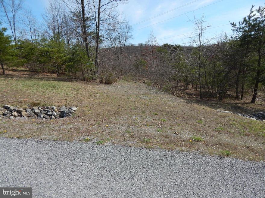 2.1137 AC in Prestigious Cacapon South. Featuring paved roads & mt. views, this is the perfect location for full time or weekend retreat. 10 M South of Berkeley Springs & w/in 20 M of Winchester, VA for easy commuting.  Just minutes from Cacapon Resort State Park, offering 6115 acres of outdoor activities, including golf on their 18-hole Robert Trent Jones golf course, swimming in the lake, paddle boats and canoeing, horseback riding, skeet shooting, playground, newly resurfaced tennis courts, paved basketball court or sand volleyball court and vacation cabins. Two areas at the park, the lake and reservoir, offer fishing opportunities. The lake is stocked in the spring for trout fishing, but other fish that can be caught are bass, catfish and blue gill. The reservoir is not stocked. The lodge, along with a restaurant, extend first-class service year-round, with a recent lodge expansion increasing the room inventory by 80 additional rooms including a fitness area, expanded food service, sauna and indoor/outdoor pool, as well as some golf course improvements.