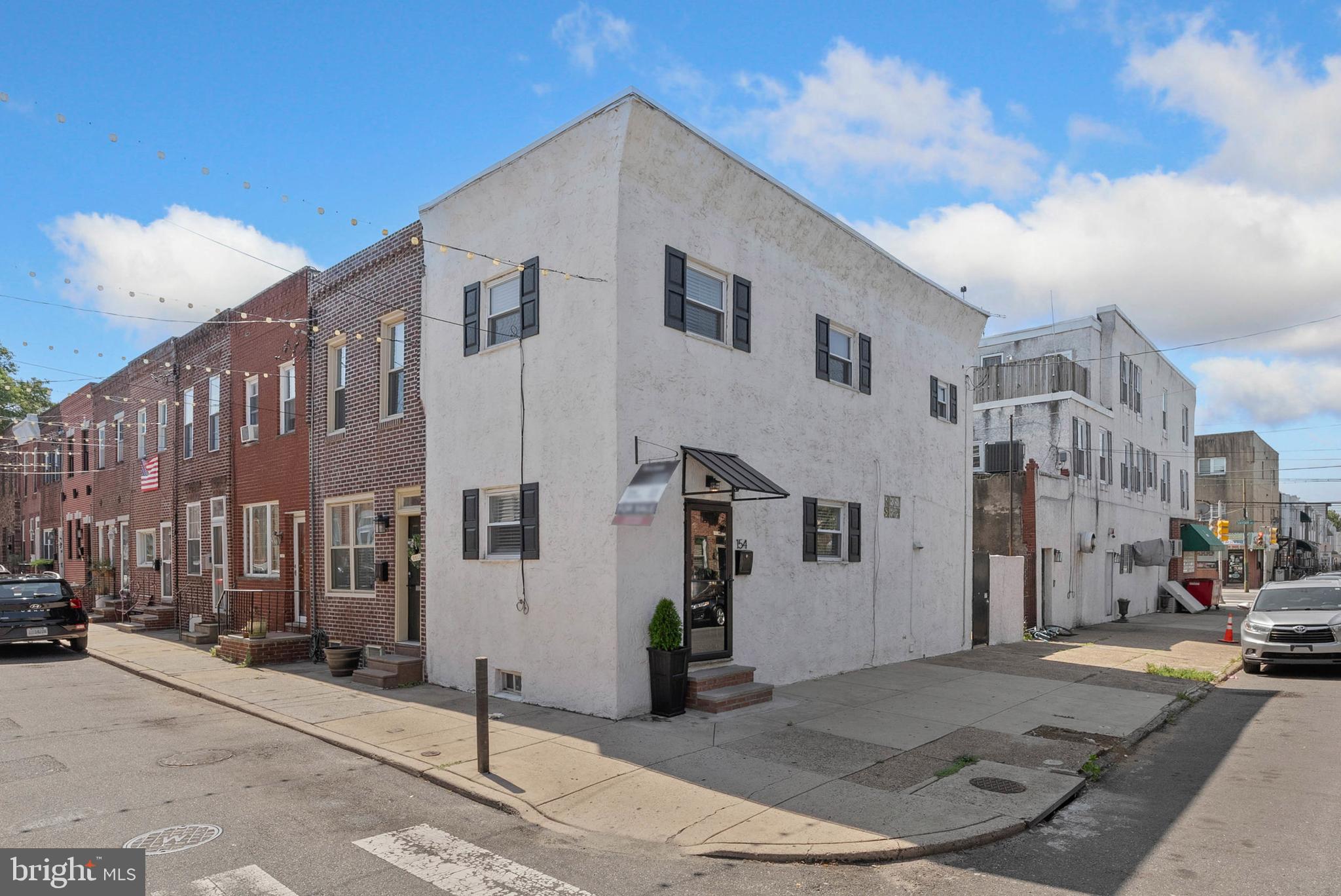Welcome to 154 Mercy St, a charming corner residence in the thriving Pennsport section of Philadelphia. This two-story gem features 2 comfortable bedrooms, 1.5 well-appointed bathrooms, a secluded courtyard, and central air. As an end-of-row home, it enjoys sunlight from two exposures, creating a bright and inviting interior throughout the day.Out front, you'll notice refreshed curb appeal, highlighted by updated shutters, a modern awning, and a recently upgraded storm door. Step inside to a welcoming living space with newly installed luxury vinyl plank flooring, great flow, and ample room to relax or host guests.The thoughtfully designed kitchen is a cook’s dream, complete with stainless appliances, generous granite counters, crisp white shaker cabinets, a stylish tile backsplash, and bar-height seating for casual meals. A conveniently located half bath rounds out the main level.Step outside to your own private patio—ideal for grilling, gardening, or enjoying an evening under the stars. Upstairs, you'll find a sleek full bath with a wide vanity and hallway linen storage. Both bedrooms offer plenty of natural light and comfortable proportions, with the primary enjoying dual exposures.Downstairs, the expansive, dry, clean basement provides laundry facilities and exceptional storage potential. 154 Mercy St's fantastic location, just off Snyder Ave, earns a Walk Score of 88! Popular restaurants, friendly shops, and local businesses fill the surrounding blocks. Parks and playgrounds are nearby, plus shopping centers with stores like Target, IKEA, Lowe's, and ACME are a short walk or drive. There's also easy access to public transit, Columbus Blvd, I-95, and South Jersey. Schedule your tour today!