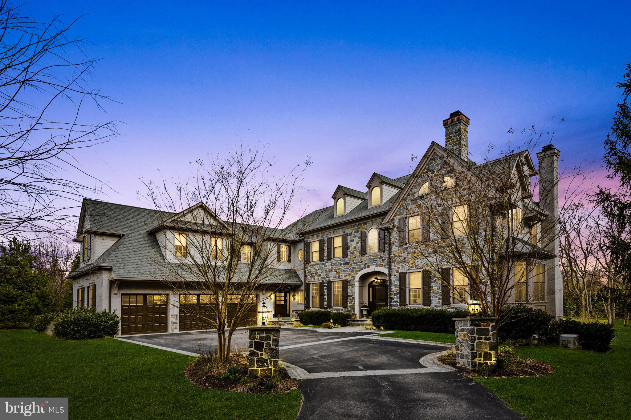 Embark on an extraordinary journey in the esteemed neighborhood of Villanova, where 777 Eagle Farm Rd redefines luxury living. Constructed by CD Hall in 2015 and designed by McIntyre Capron, this residence stands as a testament to exquisite craftsmanship and refined design across its three finished levels.
From the moment you step inside, you're greeted by an atmosphere of sophistication and comfort. The main level features rich hardwood floors and 10 foot ceilings, setting the stage for elegant living. The living room offers a cozy gas fireplace, wet bar with granite top, and a modern projector for entertainment, while the adjacent formal dining room seamlessly connects to a butler's pantry with wine refrigerator, stone counters and a tiled backsplash.
A fully paneled fireside den provides a quiet retreat, perfect for relaxation or focused work. The spacious family room, with its coffered ceiling and custom shelving, opens up to a stunning white kitchen equipped with a large island, high end appliances and ample storage. French doors lead to a covered terrace, ideal for outdoor gatherings under twinkling bistro lights.
Convenience meets luxury with an additional office near the mudroom and garage, ensuring functionality without sacrificing style. Upstairs, the primary suite boasts a Juliette balcony, gas fireplace, and generous walk-in closets (his and hers). The shared bath features radiant heat floors and a steam shower for ultimate relaxation.
Three additional bedrooms, each with its own bath, offer comfort and privacy, while a fourth bedroom suite provides extra space for guests or work. An elevator chase serves all levels, anticipating future needs with ease.
In the walkout lower level, a gym and half-court basketball area cater to active lifestyles, while a full bath and recreation area offer ample space for leisure activities.
Situated on almost 2 acres, this home is primed for outdoor enjoyment, with pre-installed electrical conduit for a future pool and pool house. With meticulous attention to detail and modern amenities throughout, 777 Eagle Farm Rd presents an unparalleled opportunity for luxurious living in Villanova.