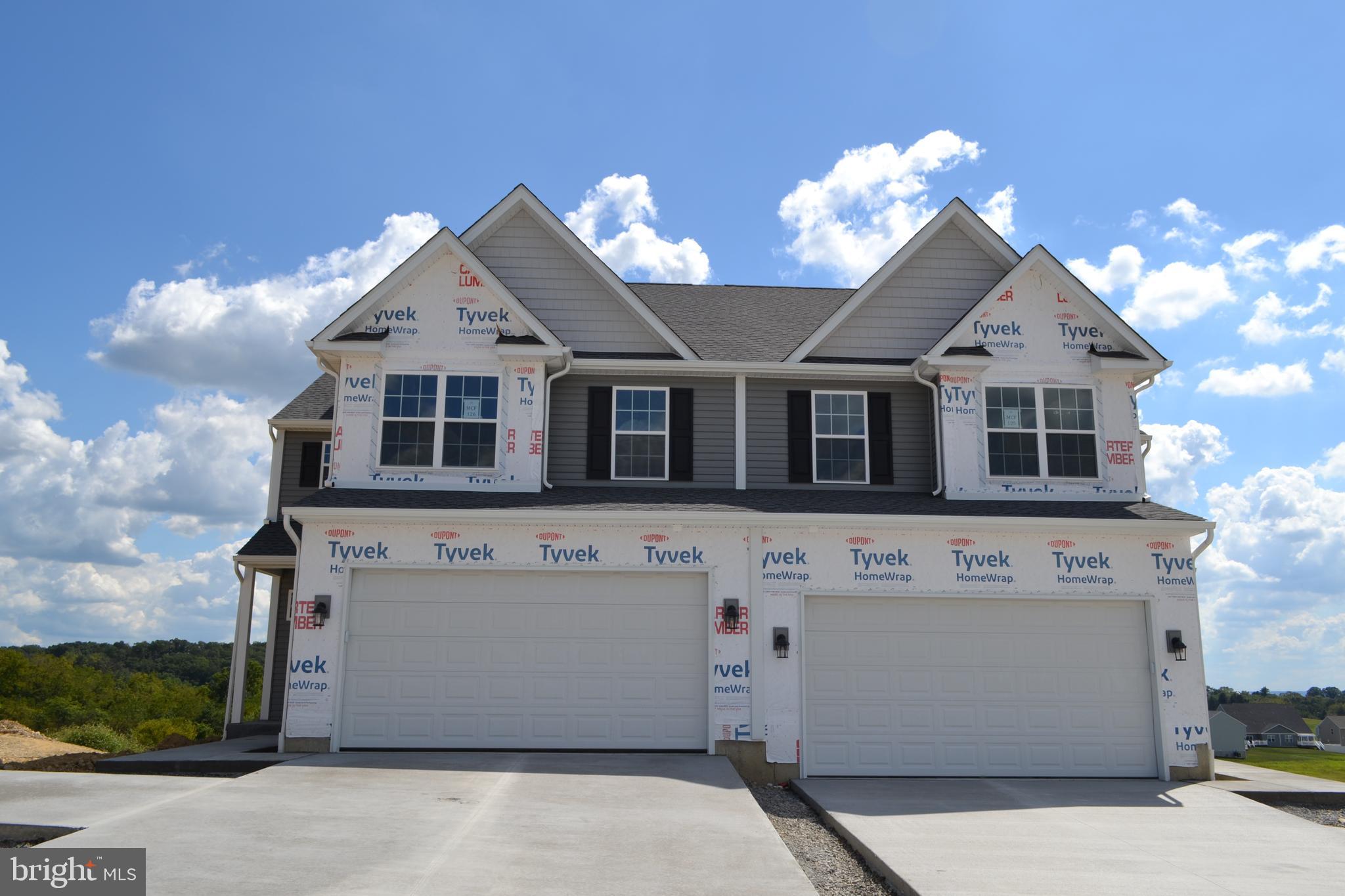 ALMOST COMPLETED! Popular Durham Floorplan with WALK-OUT BASEMENT ready for September closing! This spacious Durham design includes over 1,800 square feet of living space. Starting with the unique private/angled entry and covered porch, you're immediately drawn into the living room, with easy access to the two-car garage and first floor powder room. Beyond the living room is the dining room with tray ceiling that is open to the kitchen, providing an air of open living. The L-shaped kitchen includes ample quartz countertops, including an island with an overhang and accented with a lovely tile backsplash! Just up the split staircase is a full bath with linen closet, and two spare bedrooms, each with large closets. Second floor laundry! Finishing off the Durham is the spacious primary suite featuring a sitting area, walk-in closet, and en-suite bathroom with a double vanity, and shower. One year limited builder warranty included!