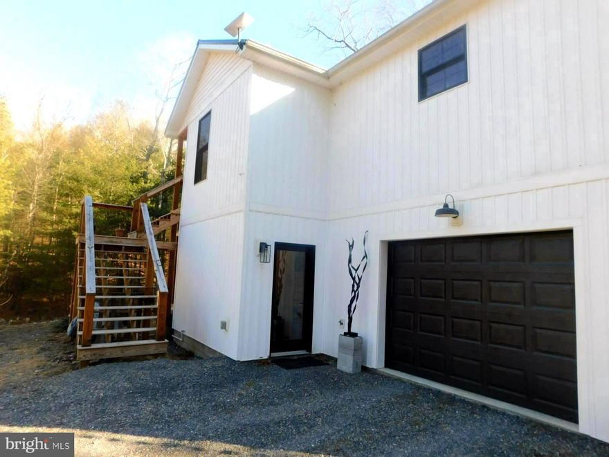 Custom-built contemporary cabin built in 2023.  This one of a kind home is located in Trout Run Forest subdivision and has walking access to the George Washington National Forest. Great for hunting, fishing and hiking. The house consists of 2 levels with 3 bedrooms and 2.5 bathrooms. The entire house has Luxury Vinyl Plank floors. Main level has a spacious living room with a large wood burning fireplace and cathedral ceilings. There is a large granite Island that seats 8 guests and a beautiful, bright gourmet kitchen.  There is a screened in porch off of the kitchen area for grilling. Main level also has a large primary bedroom and bathroom and walk-in closet. Off of the kitchen area is a half bathroom and laundry room with front loading washer& dryer. The steps leading down to the lower level have a landing for easy walking. Lower level boasts two large bedrooms with closets and each has a door to the side porch where you can enjoy the listening to the babbling brook. Outside of the bedroom area is a full bathroom with a walk-in shower and a gathering area with a granite bar and wine cooler for entertaining. The maintenance closet is on this level as well as the entrance to the  temperature controlled garage. The entire house Pella windows & doors. There is whole house generator, a RV hookup that can be easily converted to an EV hookup. There is also a water filtration system.  The house in a beautifully private area but still just 20 minutes to shopping in Wardensville and 15 minutes to Lost River and Trout Pond. It is also just 2.5 hours from DC and Northern  Virginia