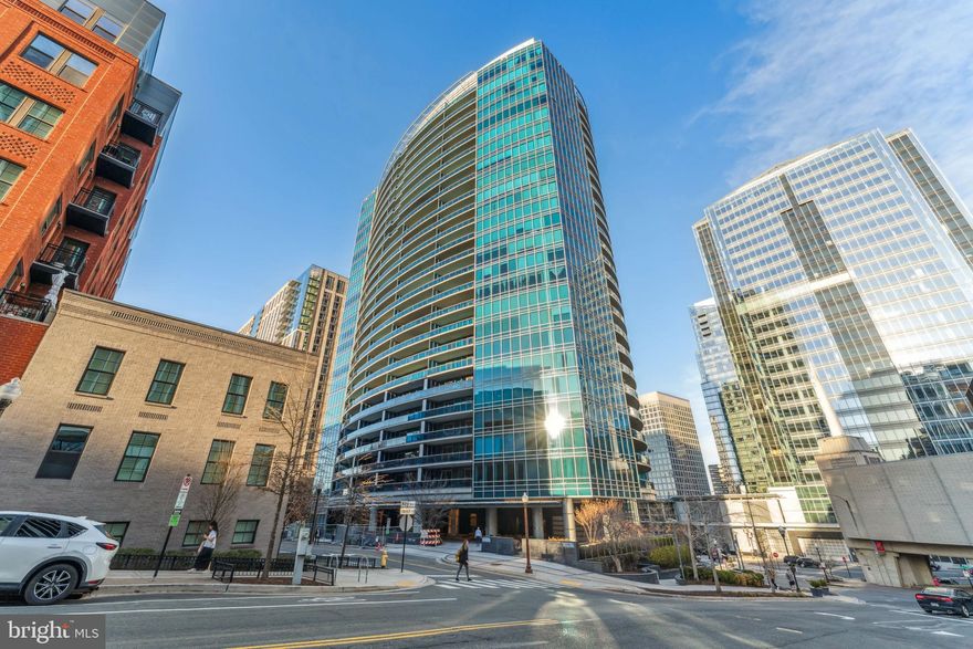 Welcome to this stunning two-bedroom, two-bath residence at Turnberry Tower, a spacious 1,754 sqft home that combines luxury and convenience. Step off your private elevator directly into an elegant living space, featuring high ceilings, 5-inch wide hardwood floors throughout, and expansive floor-to-ceiling windows that flood the home with natural light. The open kitchen is a chef’s dream, equipped with custom Snaidero cabinetry and Miele appliances.

The owner’s suite is a true sanctuary, complete with one walk-in closet, a large additional closet, and a spa-like bathroom featuring a soaking tub, separate shower, dual vanities, and designer lighting. The unit boasts a massive terrace, spanning the length of the apartment, with three access points—perfect for relaxing. A spacious laundry/storage room is conveniently located with access via a service hall and an additional elevator bank. With one deeded garage parking space and a generous 12' x 11' storage unit, convenience is key. This is a pet-friendly building.

Turnberry Tower offers unparalleled amenities, including 24-hour security, valet parking for you and your guests, concierge service, a temperature-controlled indoor pool, hot tub, fitness center, and a screening room. The community room offers an ideal space for business meetings or social gatherings.

Located 0.2 miles from the Rosslyn Metro and 0.3 miles from Safeway, the building offers easy access to a bike/jog path along the Potomac and is just a short distance from Georgetown, where you’ll find excellent restaurants, shopping, and outdoor spaces. Enjoy nearby parks, Gateway Dog Park, and the Key Bridge Boathouse for kayaking. With National Airport just 10 minutes away and the Kennedy Center only 2 miles away, this home offers the perfect blend of luxury living and a prime location.