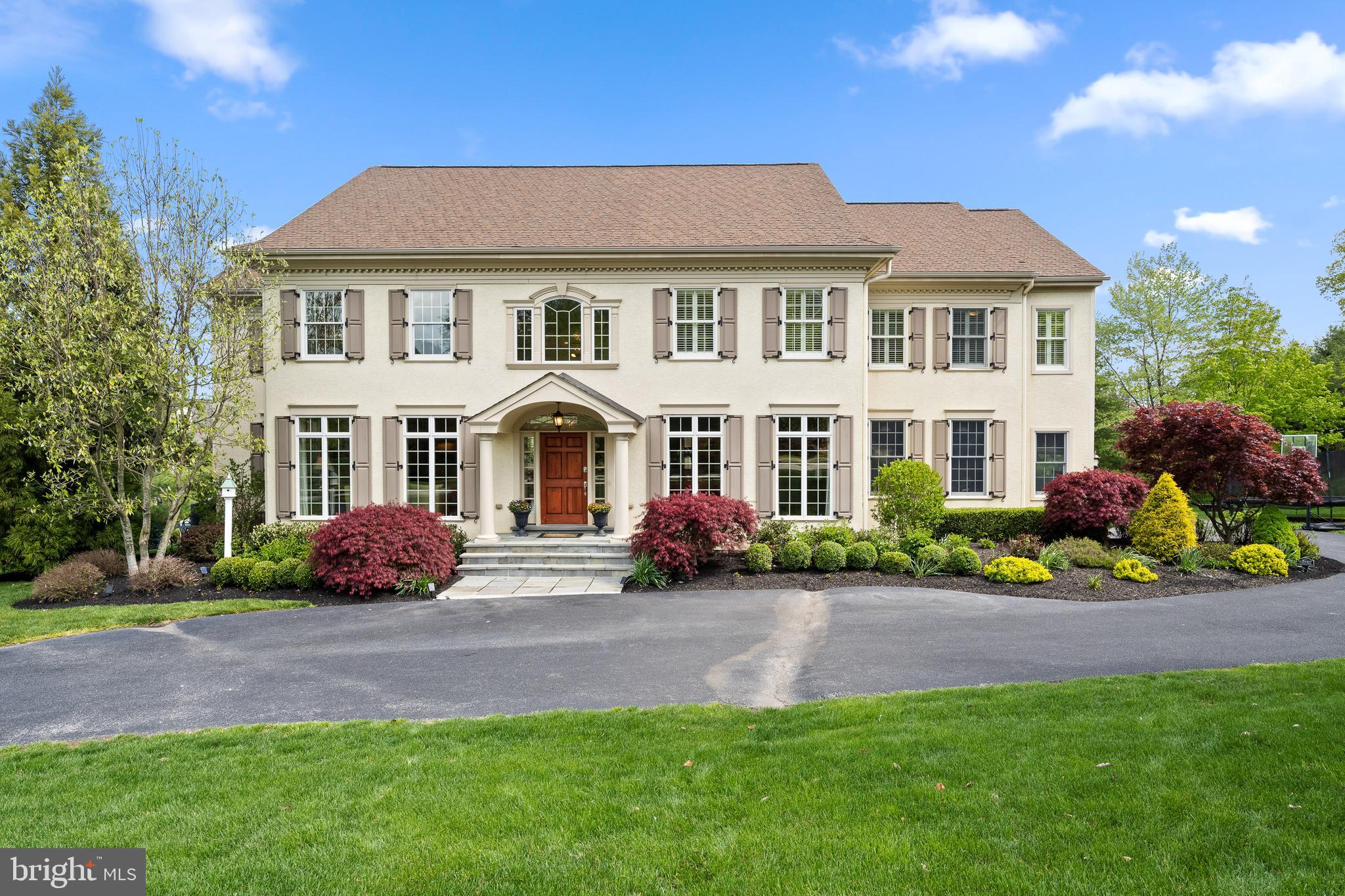 Welcome to 360 Trillium Lane, a gorgeous 6 bedroom center hall colonial, built by Bentley Homes located in the highly sought-after Whitegate community in Wayne, offering the perfect blend of luxury and convenience. As you approach the property, you are immediately struck by its stately presence, which boasts classic, traditional architecture and tasteful landscaping. This stunning home is an exquisite example of upscale living in a prime location.
Upon entering the home, you are greeted by a grand foyer that sets the tone for the rest of the home. Lovely, gleaming hardwood floors flow seamlessly throughout the open-layout, with natural light flooding each space, creating a bright and inviting atmosphere that is both welcoming and relaxing. The formal living room features floor-to-ceiling windows that warm the room and offer gorgeous views. A spacious formal dining room is perfect for entertaining and connects via the butler’s pantry to the gourmet kitchen. The large center island, topped with elegant granite countertops, compliments the white cabinetry perfectly. The custom cabinetry is beautiful and also incredibly functional, with pull-out drawers and plenty of storage space for all your cooking essentials. The stainless-steel appliances add a modern touch, with a large refrigerator, double oven, gas range and hood. The kitchen includes a spacious east-facing breakfast room, perfect for enjoying a meal with family and friends, or sipping on your coffee in the morning sun. The kitchen is open to a large family room and features two-story ceilings and a stunning window overlooking the grounds. A back hall off the kitchen provides access from the attached three-car garage, the powder room, walk-in pantry, and second staircase. The main floor is complete with a bonus room with attached full bathroom, currently used as a spacious office and den but perfect for a first-floor bedroom or guest suite.
Upstairs, you will find 5 bedrooms, each with hardwood floors and ample living and closet space. The primary suite is a true retreat, with vaulted ceilings, plantation shutters, a large walk-in closet, ensuite primary bathroom, and peaceful views over the neighborhood. A large and sunny second bedroom includes an ensuite bathroom. The additional 3 bedrooms are all spacious with wonderful natural light, and share the hallway bathroom. A bright laundry room finishes the second floor. Downstairs, the expansive finished basement is perfect for an entertainment area or additional living space. It also contains a home gym and large walk-in storage space for all your storage needs.
Outdoors is a recently constructed expansive and inviting flagstone patio designed for relaxing with family or entertaining a crowd. The patio provides ample space for outdoor seating and dining, and its exquisite design adds a touch of elegance to the outdoor area. The space is situated to provide privacy and relaxation, even a customized place for a hot tub providing resort-style living at home. The patio is also equipped with a gas line hook up, making it easy to install an outdoor grill or other gas-powered appliances. This makes outdoor cooking and entertaining a breeze, with all the amenities you need right at your fingertips. For your convenience, the house includes and in-home fire sprinkler system, three heating and air systems with five separate zones, a GE Security System, a whole-home fully integrated generator, electric pet fence, and more.
Walk over the charming stream and bridge to the neighborhood playground, basketball and tennis courts. McKaig Nature Trail, Whitegate Park and Chester County Trails are just a few blocks away. Enjoy easy access to the King of Prussia Mall and Town Center, the town of Wayne, Costco and Trader Joe’s, great restaurants, a brand-new children’s hospital (CHOP).
This home truly has it all and is perfect for those looking for luxury living in a desirable community.