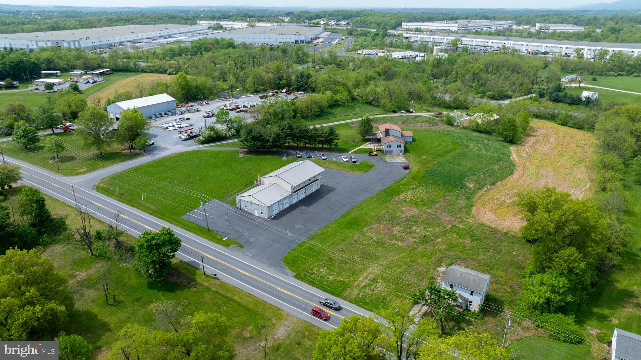 Prime Commercial/Industrial location with dual frontage on Rt. 72 and Old Forge Rd. Property is part of 7881 Logistics Industrial Park and right off of the I-81 and I-78 interchanges. 11.04 acres made up of 3 separate parcels. 2 parcels are zoned industrial and 1 acre zoned commercial. Public water and sewer with its own fire hydrant. Property features a 6 BR, 3 BA house, 5-2 BR,1 BA apartment units, unfinished 3 BR house, 40' x 96' 4-bay automotive garage with 3 separate offices, and a 40' x 80' pole barn. The automotive garage is approved for a car lot, state inspections, and manufacturing. There is a transferable variance for a junk yard on the property. A 50' right-of-way easement is deeded from State Rt. 72 to Old Forge Rd. Perfect land and location for a corporation looking to expand. Or for a businessman/entrepreneur looking to have an in-home business. Lots of potential with 3 separate tracts and more subdivisions allowed per zoning ordinance. Great warehouse/flex space waiting for your ideas. Schedule your showing today. Check with the township to confirm all options and measurements.