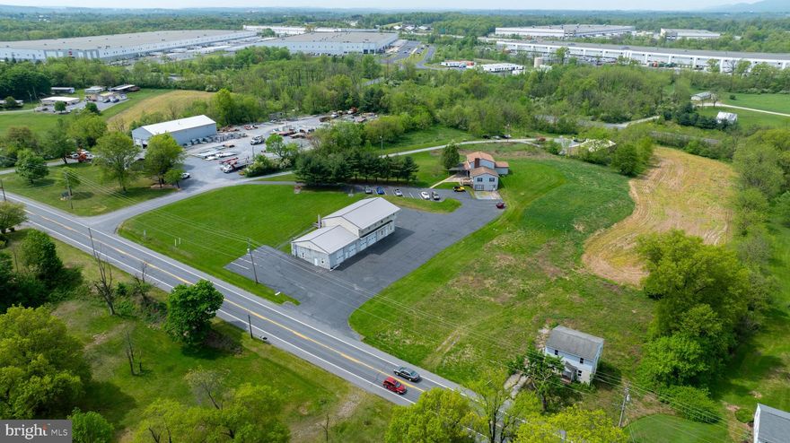Prime Commercial/Industrial location with dual frontage on Rt. 72 and Old Forge Rd. Property is part of 7881 Logistics Industrial Park and right off of the I-81 and I-78 interchanges. 11.04 acres made up of 3 separate parcels. 2 parcels are zoned industrial and 1 acre zoned commercial. Public water and sewer with its own fire hydrant. Property features a 6 BR, 3 BA house, 5-2 BR,1 BA apartment units, unfinished 3 BR house, 40' x 96' 4-bay automotive garage with 3 separate offices, and a 40' x 80' pole barn. The automotive garage is approved for a car lot, state inspections, and manufacturing. There is a transferable variance for a junk yard on the property. A 50' right-of-way easement is deeded from State Rt. 72 to Old Forge Rd. Perfect land and location for a corporation looking to expand. Or for a businessman/entrepreneur looking to have an in-home business. Lots of potential with 3 separate tracts and more subdivisions allowed per zoning ordinance. Great warehouse/flex space waiting for your ideas. Schedule your showing today. Check with the township to confirm all options and measurements.