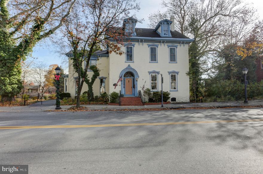 Announcing the historic brick Victorian McLean House built in 1798. Take a trip back in time as you enter the expansive grand foyer showcasing high ceilings with elegant crown molding details while boasting one of two gorgeous winding staircases and beautiful new custom windows surrounded by original folding wooden shutters throughout. She has been lovingly cared for and was most recently known as the McLean House Bed 'n Breakfast, boasting two impressive front parlor rooms with a timeless gas fireplace, a gorgeous dining room with a marble gas fireplace and its own show-stopping staircase, 6 spacious bedrooms, 5 full baths and just under 5,000 square feet of priceless character on a little over a half-acre of private secret garden settings. You might overlook the hideaway rear garden featuring a private in-ground swimming pool and patio area and red storage barn. This home was one of the first in the area to install interior gas lighting which has been converted to electric. The popularly photographed storybook carriage house sits on the edge of the Middle Spring creek and was once used as a summer kitchen with an original fireplace in the front and a horse stable towards the rear which is now a one car garage. Many updates have been made and many possibilities abound for this heirloom property located in downtown Shippensburg, PA and across from the town Library. The zoning status is Neighborhood Commercial and is in a flood zone due to the creek, flood insurance will be required for a mortgage. Cash or conventional only offers will be considered, no government loans. Please note that security cameras are on-site. Furnishings may be negotiable for sale separately. Don't miss this rare opportunity to own a stunning piece of history!