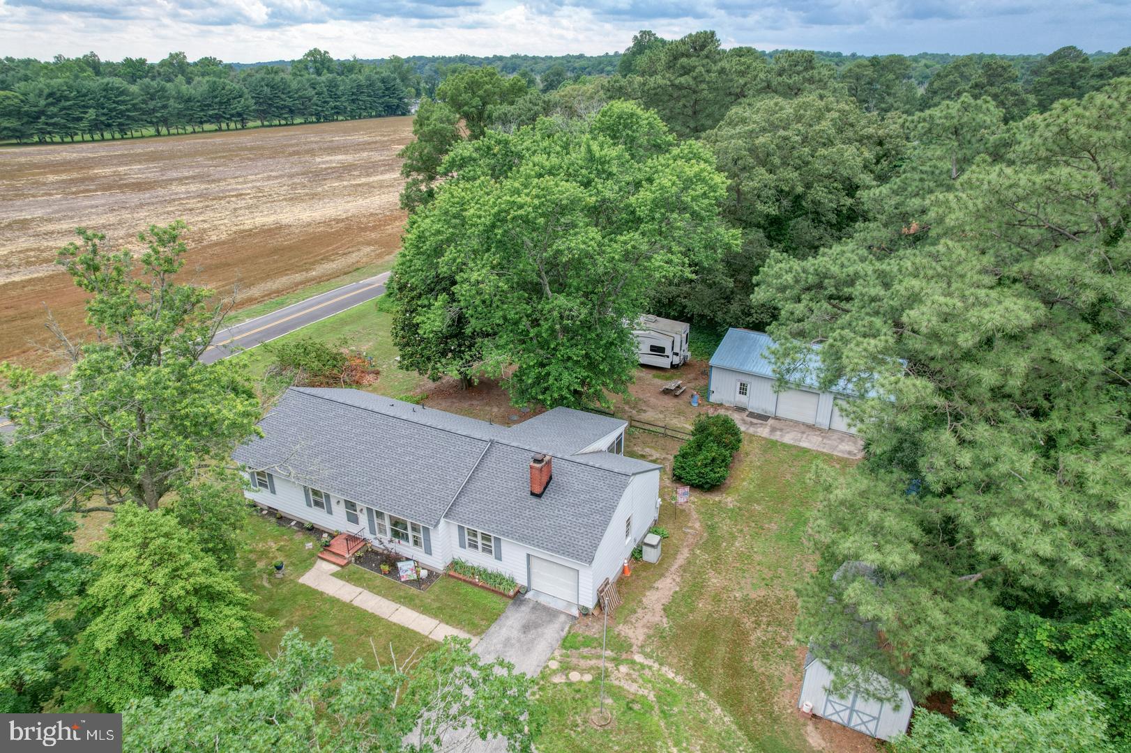 1010 S 2nd Street offers in-town living WITHOUT in-town Taxes!!! This home rests at the edge of town on 1.06 acres with mature plantings. This 3-bed 2-bath home boasts hardwood, LVP, and tile floors. A fireplace insert for the pellet stove for heat, while the seller uses the Hot water baseboard as a backup. Full basement for additional entertaining or storage. Screened-in porch overlooks backyard and large detached garage/shop. Wonderful walking experiences to school, stores, restaurants, and parks. This home shows much larger once you step in. Total sq ft for home with/ basement is approx. 2864, Seller to find HOC
