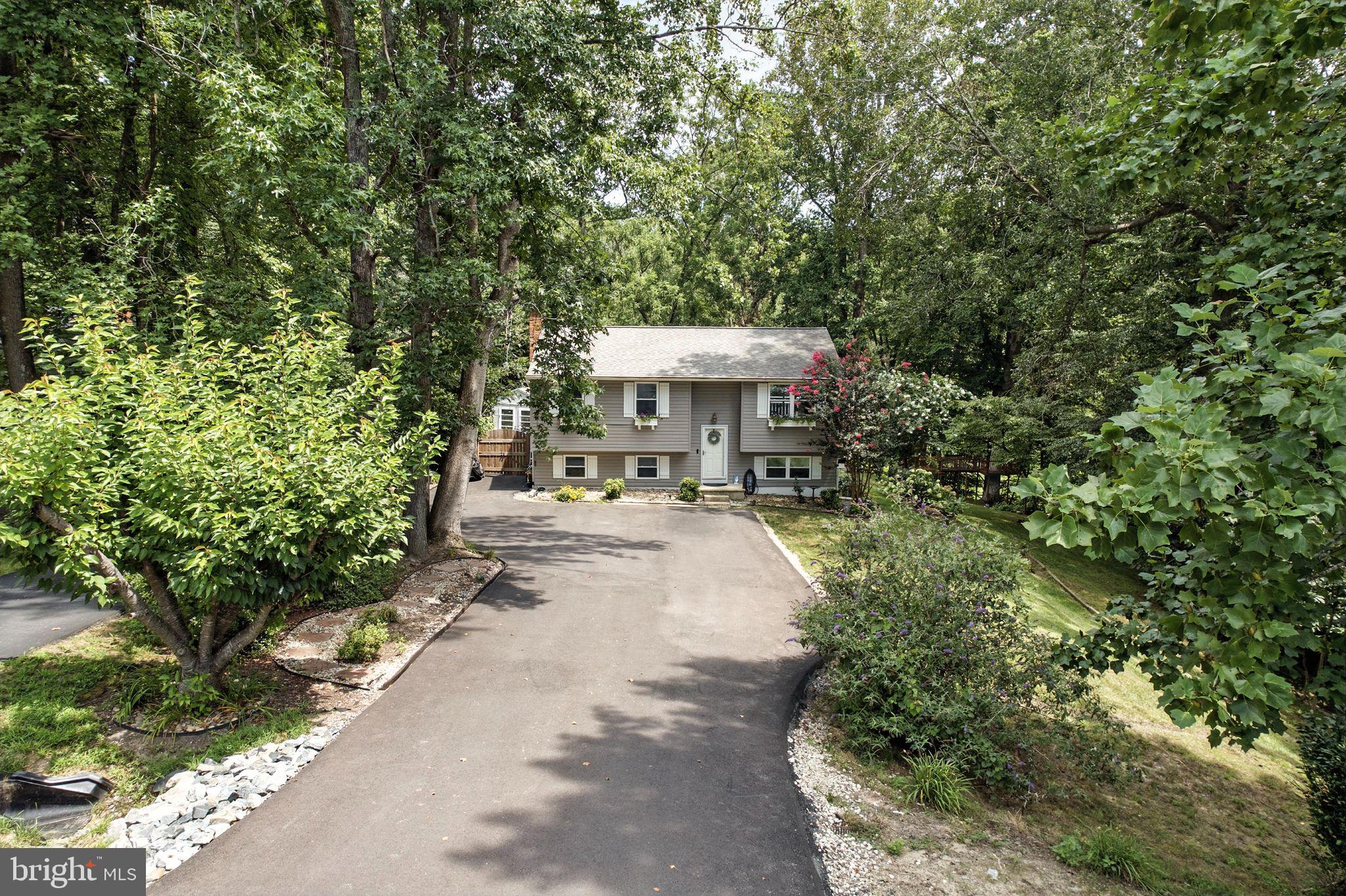 Welcome to your stay‑cation paradise! Tucked at the end of a cul‑de‑sac on 0.83 acre, this split‑foyer home backs to protected land and offers a resort‑style back yard. Enjoy a heated Stevenson Gunite pool (Raypak heater 2023) surrounded by a two‑level deck, tiki hut/bar, paver patio and koi pond with a waterfall. A tree‑fort playground, fire pit and pool house make entertaining effortless, and a privacy fence with gate (2022) gives peace of mind.
Inside, the bright, open floor plan features three bedrooms, two updated baths, a cozy living room with wood stove, and a finished walk‑out rec room. The kitchen boasts new GE stainless appliances, including an air‑fryer range and side‑by‑side refrigerator (2023) and dishwasher (2024). Major upgrades include new siding (2017), extra‑wide asphalt driveway (2025), front porch with paver walkway/patio (in progress) and added steps to the treehouse (2023).
The property borders hiking trails and is minutes from Calvert County parks, marinas and beaches for boating, fishing, swimming and crabbing. Herrington Harbour South, Cove Point Pool and Chesapeake Beach Water Park provide endless recreation, while Annapolis (≈30 min), Joint Base Andrews (≈35 min) and Washington, D.C. (≈45 min) are within easy commute. A rare opportunity to live, work and play in one extraordinary setting!