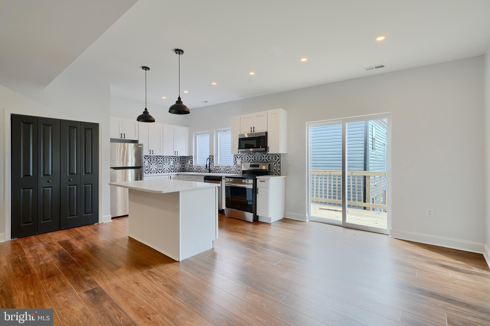 Modern 2 bed, 1 bath apartment available now in the center of Hampden, right on Falls Rd. This second-floor unit offers 1,000 sq ft of open living space with 10-foot ceilings, energy-efficient HVAC, a fantastic deck space right off of the kitchen and main living area, and a clean, smart layout. The kitchen and bathroom feature bold black mosaic tile, granite counters, and brand-new stainless steel appliances. You’ve got in-unit laundry, off-street parking, and access to a shared yard. Pets considered case by case. ** Steps from local spots like Wicked Sisters, MOM’s Organic Market, Giant, The Rotunda, and Artifact Coffee. Ideal for students, young professionals, or remote workers looking for a sharp space in a prime location. Preference for a multi-year lease.