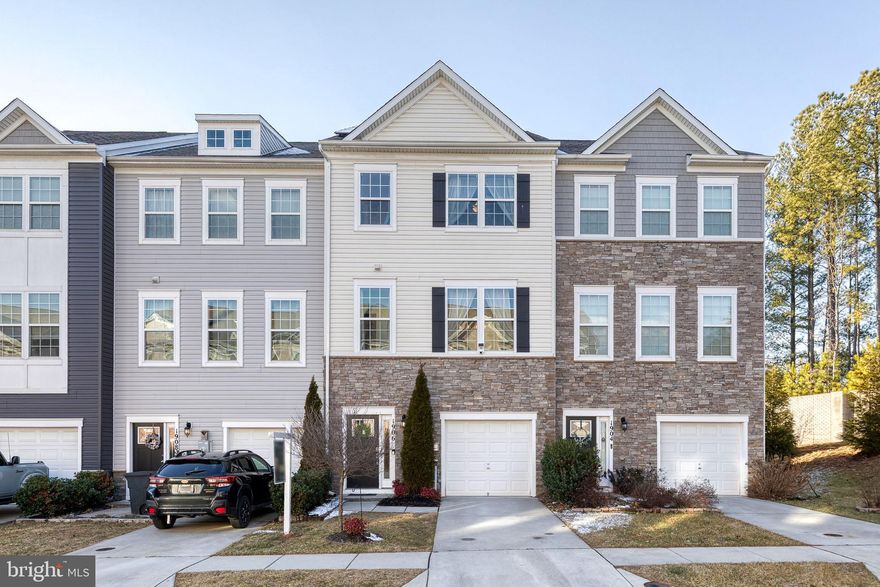 Constructed in 2019, this rare 4 bed/3.5 bath townhome, situated in the highly desirable neighborhood of Odenton Town Center, is perfect for large and multigenerational families. Enter through the front door or  garage into a bright and welcoming foyer. This main level offers a roomy 4th bedroom and adjoining full bathroom, a nook perfect for your home office or additional living space, and provides access to the serene hard scaped rear patio. Up one level you'll find a spacious open layout featuring wide-planked LVP flooring, a gourmet eat in kitchen with large island, quartz countertops, and stainless steel appliances, flowing seamlessly to both the large family room and dining spaces.  A cozy deck, convenient half-bath, and pantry complete the level. The third floor consists of the primary bedroom and ensuite bathroom with dual vanity and walk in closet, 2 more generously sized bedrooms, a third full bath, and laundry closet. Roof (with energy saving solar panels), HVAC, Hot Water Heater, and Appliances are only 6 years young. Community amenities include an adorable tot lot and nearby trails. Conveniently located to major commuter routes, Fort Meade, BWI Airport, Arundel Mills Mall, Live Casino, restaurants and outdoor recreation. Don’t miss the opportunity to own this incredible townhome.