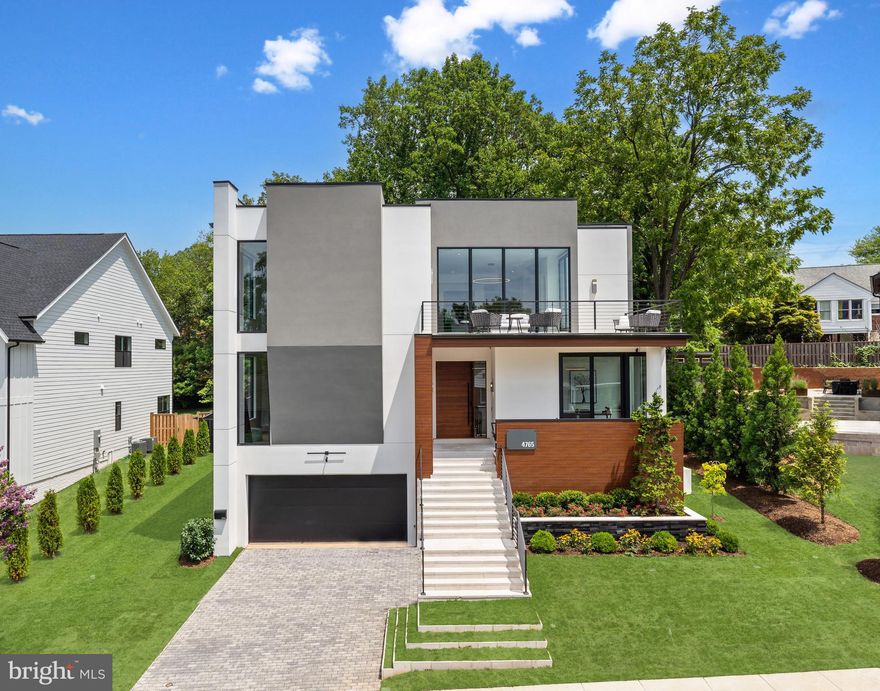 Prominently sited on a 0.25-acre lot within a private cul-de-sac, 4765 33rd St N presents a breathtaking modern masterpiece in Arlington’s Shirley Woods neighborhood. Designed and built by iCubeHomes, this 3-level, 7,900 total square foot residence features incredible scale, designer fixtures, custom finishes, a full-service elevator, and top-of-the-line smart home technology to present luxuriously contemporary design, modern comfort and everyday convenience. Outfitted with Alexa Echo devices, in-ceiling speaker system, Ring Elite Cameras and Video Doorbells, every detail of this spectacular home has been carefully executed to offer an unparalleled living experience. Complete with 6 Bedrooms, 6 Full Bathrooms, and 2 Half Bathrooms, this extraordinary residential marvel is an opportunity you don’t want to miss.
<br>
<br>
A modern pivot Front Door opens to debut the Main Level’s stunning entertaining salons. Soaring 10’10” ceilings, designer lighting, and engineered hardwood floors span the level’s offerings, to include an Eat-In Chef’s Kitchen by BAUFORMAT boasting high-end Miele appliances and PITT gas cooking, the Living Room adorned with a 72” modern luxury natural gas fireplace and floor-to-ceiling Buoyant Wine Storage/Bar, Dining Room, Powder Room, and Study featuring built-ins and a private Front Porch entrance. Lending the opportunity for prime one-level living, an ensuite Bedroom with a large walk-in closet completes the Main Level’s offerings. Accessible by elevator or the breathtaking floating Glass Staircase, the Upper Level hosts 3 of the home’s private suites adorned with 10’5” ceilings. The Upper Level’s Owner’s oasis debuts an extraordinary sanctuary with an expansive His & Hers California Closet, Private Balcony, and indulgent spa Bathroom boasting Porcelanosa Tiles, freestanding tub, frameless glass stall shower, floating dual vanity by Bauformat, separate water closet, and water-resistant in-ceiling speaker system. 2 Additional ensuite Bedrooms, each with walk-in closets, a spacious Family Room, a Laundry Room, and a lengthy Balcony round out the Upper Level amenities. The multifunctional Lower Level features a spacious Recreation Room with a fully outfitted Wet Bar, a flex space for an Exercise Room or 6th Ensuite Bedroom, an additional Ensuite Bedroom, a Powder Room, Utility Room and access to the attached 2-Car Garage.
<br>
<br>
Located in an exclusive Arlington enclave, residents of this divine residence enjoy close proximity to Washington Golf & Country Club, dining and design destinations of Northern Arlington, local parks and trails, and effortless access to major highways.