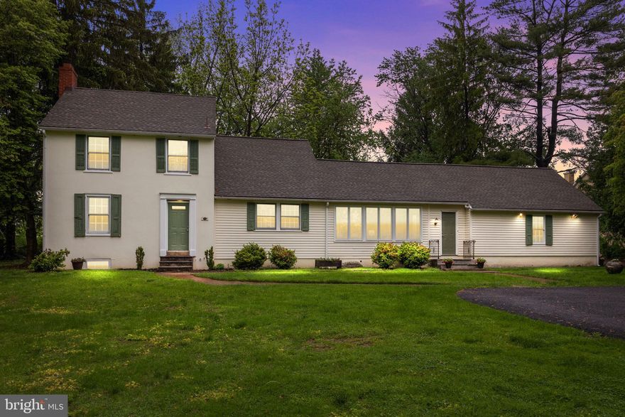 A Hidden Gem…accessed through a private gravel lane under a canopy of trees, this enchanting 1947 Robert Hunt residence—designed by noted architect Charles Abbe—offers a front-row seat to nature on a lush, private half-acre lot filled with mature landscaping and majestic trees.
This skillfully designed farmhouse-style home blends timeless design with thoughtful updates. The original structure features smooth stucco over block, with later additions including horizontal clapboard siding, a spacious family room, and a modern side-entry 2-car garage.
Step inside to a gorgeous living room with windows on three sides, a stunning mantled fireplace, custom built-ins, high baseboards, and beautiful hardwood floors. The formal dining room and welcoming foyer also feature real hardwoods and classic millwork. The adjacent kitchen blends vintage charm with modern touches—period-style cabinetry, granite countertops, a Mercer tile backsplash, and a pantry offering abundant storage with double windows over sink offering serene backyard views.
The expansive family room impresses with a handcrafted timber wall accented by vintage pegs and unique glass panels, an exposed beam ceiling, and front-to-back windows with sliding glass doors opening to a rear deck—perfect for entertaining. A mudroom with Mercer tile flooring connects to the full bath/aundry room and garage. The walk up level of the garage offers tremendous storage or potential expansion.
Upstairs, a lovely turned wood staircase leads to three bright and charming bedrooms, each with gleaming hardwood floors, solid paneled doors and overhead lighting. The full bath features ceramic tile flooring, built-in shelving, and tiled walls.
Outdoors, enjoy a fire pit in the serene backyard surrounded by towering trees and natural beauty.
Located in the highly sought-after Council Rock North School District, and just minutes from the shops and dining in the Village of Newtown, with easy access to major highways—this is truly a one-of-a-kind opportunity. Tour today!