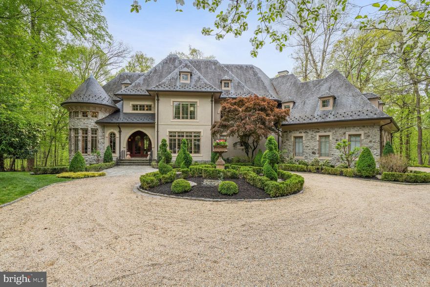 MARWOOD MASTERPIECE!! WORLD-CLASS LUXURY DESIGN!!  Featured in Home Beautiful & Décor Magazine, this magnificent 4 bedroom, 5.5 bathroom, 3- car garage masterpiece is simply beautiful beyond compare! Situated on over 1.5 acres in the exclusive Marwood community, this impeccably landscaped property alongside the Potomac River backs to the C & O Preservation Area, providing endless privacy. Designed by Sutton & Yantis Architecture and executed flawlessly by Mitchell & Best and Visnic Builders, this 8000+ sf home is pure luxury with unmatched details and style. Every room has been meticulously decorated by Barry Dixon Interior Designs. Magnificent glass front doors flanked in stonework set the tone for what lies beyond. As you enter, your eye is immediately drawn to the spectacular wrought iron helix grid pattern staircase swirling down 3 stories with a backdrop of floor to ceiling windows overlooking the Potomac River, and from there every single square foot provides another wow moment. From the custom wood arched entrances to the wood detailed ceilings and the soaring windows, each room holds an unexpected delight. The main level features hardwood floors, a dramatic music room with glass paneled French doors, an office with endless custom wood built-ins, a 2-story great room anchored by a grid of concrete panels abov ethe fireplace,  a reading nook with movable bookcases, a spectacular dining room, a butler’s pantry and a beautiful atrium. An African slate tiled powder room with cast-stone sink is secret grotto tucked behind the main entry. Inspired by vintage French enamelware, the  kitchen is divided by the cruving breakfast bar into semicircles for cooking, eating and entertaining,  and the steel and metal, wood, stone and tile display an interesting visual effect.   The  wire mesh cabinets fronts, the  galvanized steel countertops, a stone hearth across the room creating a cozy spot for dinner, and a  upholstered round banquette with an overscaled iron chandelier, and desk area complete the dramatic kitchen.  From here, direct access to the private flagstone patio and access to the oversized side-loading 3 car garage.  As you ascend the awe-inspiring staircase you are instantly amazed by  the majestic dome ceiling and unique light fixture. The expansive primary suite hosts a serene sitting room, 2 spacious walk-in closets and a dressing area, access to a private balcony and a luxurious en suite bathroom with a free-standing jaccuzzi tub and a separate shower. A lovely reading nook/social lounge area with built-in seating and bookcases, two large secondary bedrooms with en-suite bathrooms, and a laundry room with ample storage  complete the carpeted upper level. The lower level boast a dramatic end of the staircase in a pit of gravel set with a stone garden table and stools, a secondary kitchen,   a fabulous 1000 bottle wine cellar, a bedroom with an en-suite bathroom and access to the private backyard, a movie room, a gym with mirrored walls, a sauna and 5th full bathroom and extensive storage. Every wall has been custom painted and custom wall coverings can be found throughout the house. No cost was spared!!  This house is undeniably one of a kind!  Relax and enjoy the tranquil resort-like backyard, just minutes to shops, and restaurants of the Potomac Villiage!