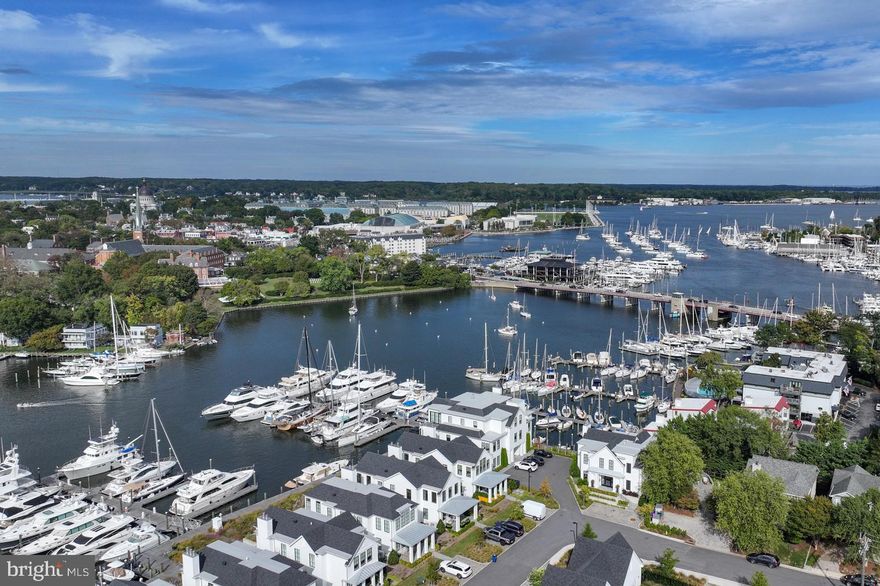 A new standard of waterfront living unfolds at the South Annapolis Yacht Centre, a boutique enclave of just eleven luxury residences rising along the edge of Spa Creek where Eastport’s maritime heritage meets modern design. Set within this celebrated marina village, Residence #4 is a rare two-level duplex that captures the beauty of the water and the energy of downtown Annapolis from every vantage point.
The residence blends architectural precision with coastal ease. The main level welcomes guests through an elegant entry hall leading to a great room featuring gorgeous wood floors, ample seating around a gas fireplace, a huge island with Quartzite counter, and incredible views down and across Spa Creek. The door to the waterfront deck folds back to create a seamless transition between inside and out; even in colder weather, the number of windows and the size of the doors bring the views of the city’s spires in full focus. The chef’s kitchen includes a double Wolf range and Sub-Zero refrigerator with custom freezer drawers, and there’s plenty of room for multiple chefs to work together! The floor plan also includes an office area with powder room, and the owners installed a beautiful bar with beverage refrigerator and ice machine. The spacious bedroom suite offers a luxurious ensuite bath, and the large walk-in closet has a full-size washer and dryer.
Descend via the private elevator to the lower level, where a second bedroom suite opens to an enchanting waterside deck. There’s a spa-inspired bathroom, walk-in closet, and wet bar with mini-fridge, creating a self-contained sanctuary ideal for visiting friends or family.
Every element of the home reflects the craftsmanship and intent that define the South Annapolis Yacht Centre—an award-winning waterfront community designed by ABS Architects and constructed by Pyramid Builders. The property integrates modern architecture with the rhythms of marina life, offering 74 deep-water slips, a private boardwalk, and access to the full-service marina’s amenities.
Anchored in Eastport’s vibrant waterfront district, the South Annapolis Yacht Centre celebrates the best of Chesapeake Bay living — where sailing heritage, walkable streets, and panoramic water views converge into an atmosphere of understated elegance. 289 State Street, Residence #4 offers more than a home; it offers a lifestyle defined by craftsmanship, connection, and the timeless allure of Annapolis.