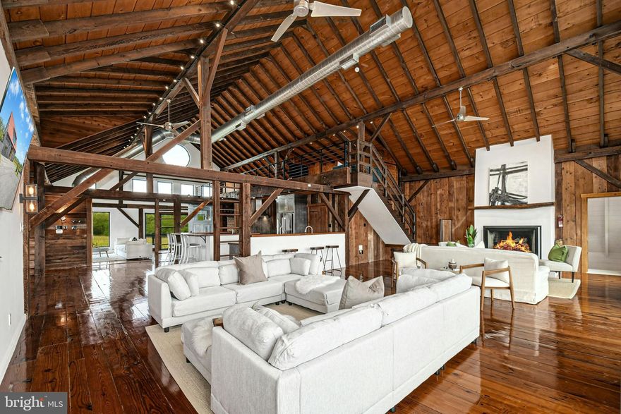 The very essence of a Bucks County gentleman’s estate is evidenced at first approach…turning off a quintessential country road, meandering down a long, tree-lined drive, all surrounded by breathtaking views of the Durham countryside that include long distance vistas over the Delaware River Valley. Sequestered on 90 acres, the setting is a unique and timeless representation of the magic for which Upper Bucks County is famous. 
Spring Hill is a rare and beautiful example of a barn renovation with re-imagined vaulted spaces, blended with stunning new architectural details, re-purposed barn beams, and antique wood. The seamless blend of original features and new renovations amazes and delights. These rich patinas, combined with incredible space and light, are testament to the skill and execution of the owner/architect.
Spring Hill sets the bar for every romantic estate and may be the best property you will ever see. The buildings and pool have been perfectly positioned, amidst the rolling acreage, overlooking views of manicured farmland, gardens, and specimen plantings…all beckoning morning walks and sunset contemplations. 
Designed to enhance beauty and livability, the sun-filled spaces offer panoramic vistas of protected environs. There are amazing spaces in which to entertain in large numbers. Six bedrooms and nine baths invite family and guests, and a separate guest apartment will pamper all, while providing a comfortable space apart. Additionally, 9 car garaging invites car enthusiasts and collectors alike. The heated pool, spa and adjacent pool house are dramatically positioned amidst the serene views. For the horse enthusiast, the property is a blank canvas for future equestrian pursuits.
Spring Hill is one of the jewels of Bucks County, in an exquisite and secluded setting. Every aspect, both inside and out, is presented artfully and joyfully. This private paradise loses touch with the world just over the hills yet is still within easy driving distance to the magic of Bucks County dining, antiquing and recreation.