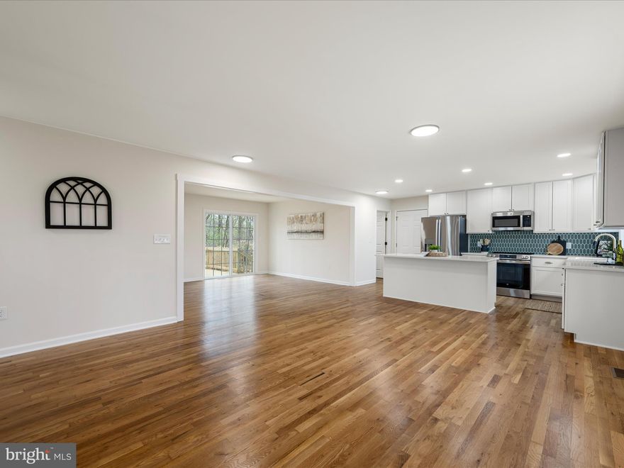 PRICED REDUCED by $25k! Fully Renovated & Move-In Ready with Shenandoah River Access! This beautifully updated 4-bedroom, 3-bath home has been fully renovated and offers updated, turnkey living in a peaceful setting just minutes from Harpers Ferry—with community access to the Shenandoah River. Step inside to a stunning open-concept kitchen and living area featuring quartz countertops, GE stainless steel appliances, soft-close cabinetry, a tile backsplash, and a spacious dining area. The kitchen flows seamlessly into the light-filled living room with hardwood floors and walkout access to the main-level deck—perfect for entertaining or everyday enjoyment. The first-floor primary suite is a true retreat, offering a spacious layout and a beautifully renovated ensuite bath with a soaking tub, separate shower, and modern, custom finishes. A second main-level bedroom and full hall bath provide flexible space for guests, a home office, or additional family. Upstairs, a large family room opens to the upper-level deck, and two oversized bedrooms share a full bath.  The laundry room and attached 2-car garage are off the kitchen and add convenience and function to the home.  Outside, enjoy the brand-new two-level deck overlooking the quiet treed yard, and take advantage of private community river access just down the road.  This home has been fully renovated with: new roof, new siding, new gutters and downspouts, new HVAC system, brand-new kitchen and baths, new carpet, LVP, hardwood floors, fresh paint, and more.  This one is truly move-in ready with nothing left to do!