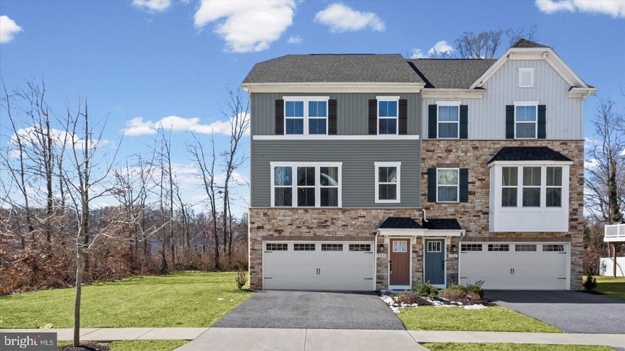 A stunning 3BR/2BA/2HBA move-in ready semi-detached Townhome featuring three floors of pristine living space is located in the desirable neighborhood of QUIET WATERS AT NORMAN CREEK.  Park in the double wide driveway just outside the two-car garage and make your way to the front door of your new home.  The entry level offers indoor garage access, a half bath, a spacious family room, storage, utilities, and a walk-out to the yard.  The main floor living space features the open-concept floor plan that homeowners seek, boasting abundant natural light, luxury flooring, high ceilings and recessed lighting.  This floor offers a large living room, a dining room, and a gorgeous kitchen. The kitchen features plenty of cabinets finished with crown moldings, a separate pantry closet in the dining area, stainless steel appliances, sleek quartz countertops with a penny tiled backsplash, a deep stainless sink under a window, and a large center island ideal for hosting family and friends, which also offers breakfast seating. From the dining area step out onto a balcony that overlooks the yard with green space and backs up to a forest area. The second floor offers two sizable secondary bedrooms, a full bath, convenient second-floor laundry, and a primary suite.  The primary boasts a tray ceiling, a large walk-in closet, and an en-suite featuring a double-sink vanity and a large walk-in shower with a built-in bench. This move-in-ready home is ideal for any new homeowner, and is located near shopping, restaurants, and commuter routes.