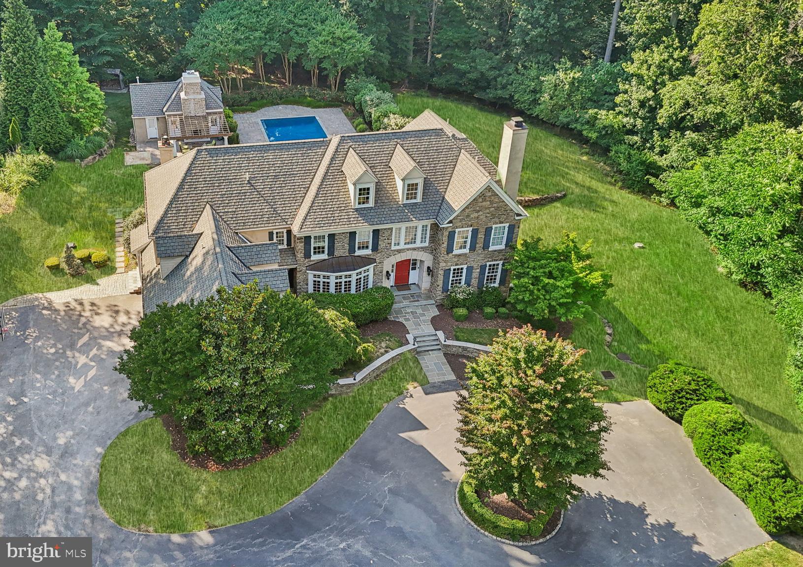 Only a relocation could make this beautiful home available - welcome to 413 Timber Lane! This amazing property has been lovingly renovated over the last year and offers 5 bedrooms, 5.2 bathrooms, and is situated at the end of a cul-de-sac street that overlooks the greens of Aronimink Golf Club. As you drive up to the circular driveway and enter through this center hall colonial, you are greeted with architectural details and interior finishes such as newly finished wide plank oak flooring, custom millwork and wainscoting, designer and recessed lighting, and wide arched doorways - you will sure to be impressed! To the right of the foyer there is the formal living room with a gas fireplace that opens to the spacious professional office with built-in cabinetry, shelving and a large Subzero wine fridge with two temperature control options and two separate refrigerated drawers. To the left, the expansive dining room comfortably seats 10+ people and connects to the walk-in pantry and “command center” with built-in desk offering the ideal space for a second office. Truly the heart of the home, the kitchen boasts a massive island spanning over 50 square feet with new quartz countertops, commercial grade built-in appliances -- including two dishwashers and brand new Wolf microwave and warming drawer -- and adjacent breakfast room with vaulted ceiling. The show-stopping family room directly off of the kitchen offers an open concept space with a cathedral ceiling, gas fireplace, and an abundance of windows offering a beautiful view of the estate. This floor is completed with 2 powder rooms. The first sits off the mudroom with four built-in cubbies, a rear staircase to the second floor and access to the 3 car garage. The second is oversized and offers exceptional marble floors and all new finishes. The second level offers an oversized primary suite with sitting room, tray ceiling, his/her walk-in closets with built-in shelving systems, and a new luxurious tiled bathroom featuring dual vanities with quartz counters - one with vanity/make-up area along with a soaking tub and oversized frameless glass 3-piece shower with a quartz bench. Follow down the hall to four more spacious bedrooms – two with ensuite bathrooms and two that share a Jack & Jill bathroom; large laundry room with cabinetry and counter space; and plenty of closets for added storage. A third office area - also ideal for a homework area - sits at the top of the stairs. The lower walk-out level basement offers an abundance of light in a fresh, clean space. A new gym with stacked stone walls is the perfect spot for your morning work-out. There is also a bonus room that could be used as another office or bedroom and this level is completed with a full bathroom. The exterior of the home is not to be missed with mature and meticulously maintained landscaping that offers unparalleled privacy and serenity in a setting abundant with wildlife. The salt water pool is perfect for the upcoming summer months while the pool house with interior/exterior wood burning fireplace offers incredible living space, full bathroom, and kitchenette. This 439 finished square feet could easily be used as an in-law, au-pair, or entertaining space. All of this while being in top rated Marple Newtown School District and close to some of the best private schools in the country - Episcopal Academy (5 minutes), Academy of Notre Dame, the Haverford School and the Agnes Irwin School. Minutes to Downtown Wayne, Villanova, Media and West Chester offering an array of amazing shopping and dining options while 10 minutes to the Paoli Train Station and all major roadways for an easy commute to Philadelphia and Wilmington. Call today to see this amazing property; it is not to be missed.