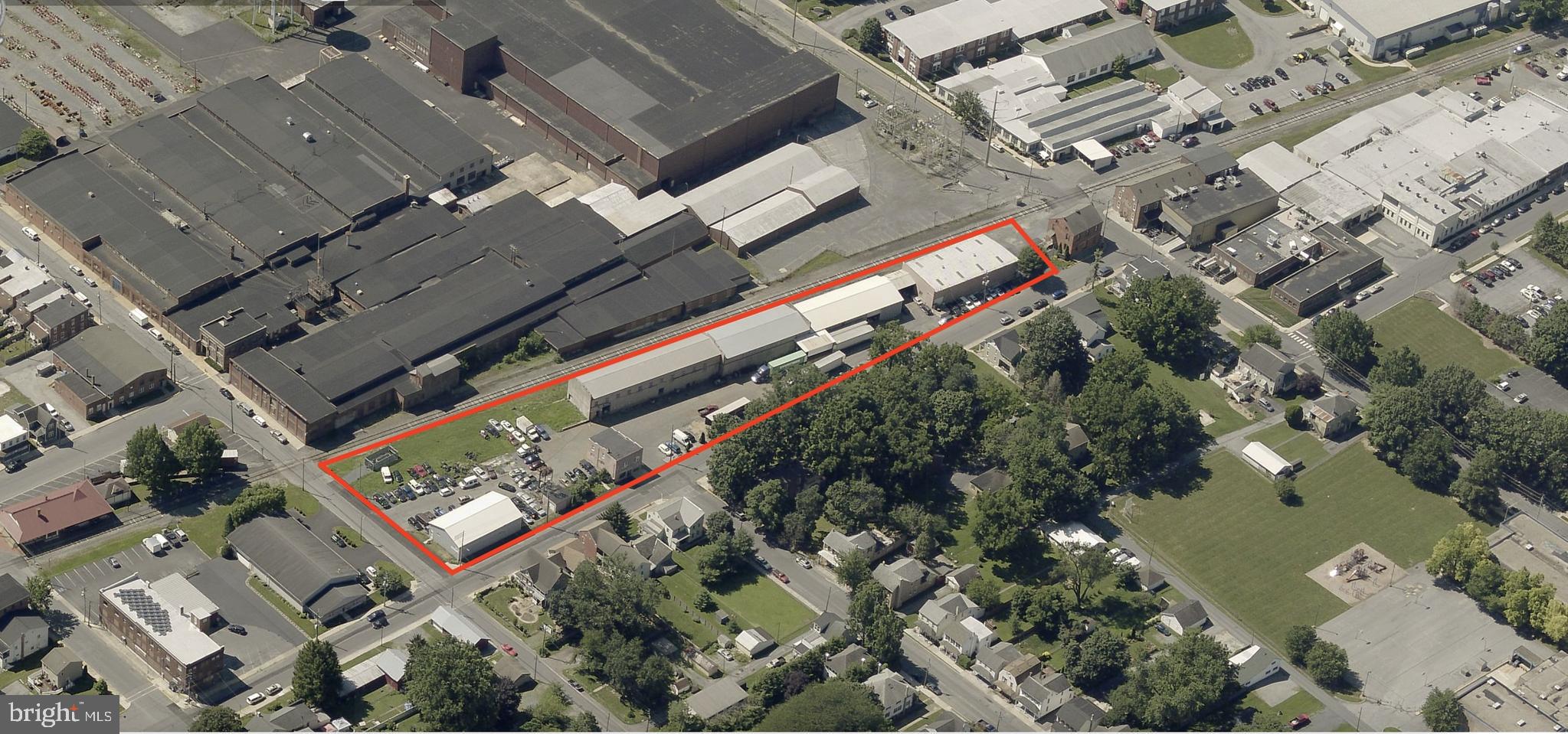 This industrial property presents a versatile opportunity with four buildings (three industrial and one 2-story office) totaling 24,537 square feet on a 1.81-acre site. Property features 7 dock-high doors and 3 drive-ins.
The largest building offers +/- 14,000 square feet of warehouse space and provides flexibility for an owner to occupy all or a portion for their business while leasing the remainder, or to lease the entire building as an income-producing investment. The two remaining industrial/auto garage are currently leased with flexible terms, allowing for conversion to NNN, rent increases, or the option for an owner to occupy the space for their own business use. The 2,472 square foot office building is currently owner occupied but will be vacated before settlement.
Building 1 - 14,000 square feet industrial/warehouse
Building 2 - +/- 4,800 square feet industrial/warehouse
Building 3 - 5,150-square-foot metal-panel industrial building, currently utilized as an automotive repair garage, and a 400-square-foot storage garage.
Building 4 - 2,472-square-foot, two-story office building.
With level street-grade access, ample parking, and strong road frontage in Manheim, PA, this property is well-suited for a variety of auto, industrial, warehouse, or manufacturing uses. The combination of owner-occupied and income-generating tenant spaces makes it an attractive option for investors and business owners alike.