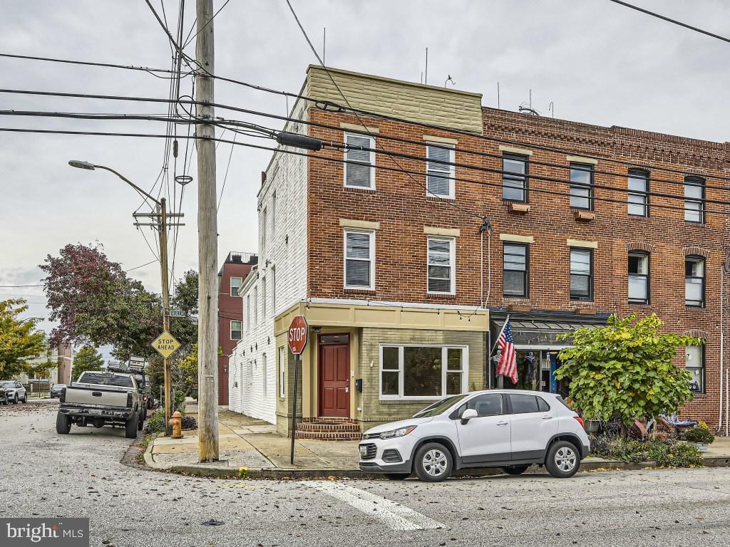 REDUCED to $560,000. Incredible Value for this 4 levels 3 bedrooms 3.5 bath end unit with garage!!Welcome to 1250 Hull St. beautiful end unit with 4 finished levels featuring quality finishing s throughout, 3 bedrooms 3.5 baths, finished basement, 2 tier roof top deck plus 1 car garage. MAIN LEVEL: Light filled 1st floor with Brazilian Cherry wood hardwood floors. Living room with large picture window. Gourmet kitchen with granite counters, stainless still appliances, gas stove, 42” cherry cabinets, glass tile backsplash and a large island for your entertainment. Exposed brick wall. 1st floor powder room and access to the 1 car garage with garage door opener. SECOND LEVEL: A beautiful staircase with wrought iron railings leads you to this level with two large bedrooms with their own baths. Both bedrooms have brand-new carpet. Washer and dryer. THIRD LEVEL: Specious primary bedroom with brand-new carpet and its own luxury bath. This level leads you to a two-tier deck with a magnificent skyline view of the city. LOWER LEVEL: Club room/office with new carpet. Back storage space. All this plus, location is everything in the desirable Locust Point. Walking distance to many neighborhood restaurants, Latrobe Park, grocery stores, Fort McHenry. Minutes and easy access to I95 for commuters. SPECIAL FEATURES: Recessed light throughout all levels. Hardwood steps all staircases. 4 Ceiling fans. Wrought iron railings. This is a MUST-SEE HOME!!