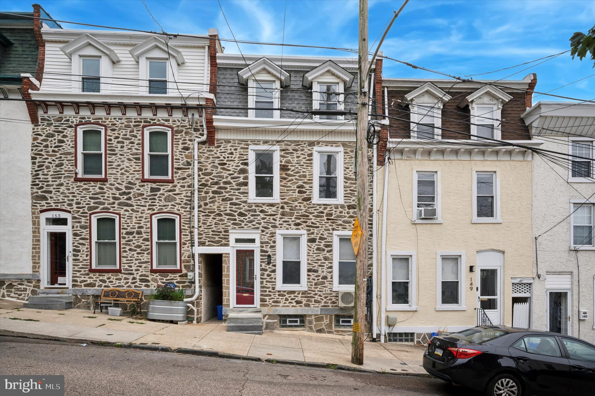 Introducing 151 Jamestown St, a newly renovated stone-front 4 bedroom, 3 bathroom home in the desirable Manayunk neighborhood. As you enter the home you will notice the large living room that opens right up to the dining room with bar area and a beautiful chandelier. It has recently refinished hardwood floors and 9 foot ceilings. The kitchen is gorgeous with brand new white cabinetry, brushed nickel hardware, subway tile backsplash, quartz countertops, stainless steel appliances including a 5 burner gas range, and a large sink that overlooks the covered porch and rear patio. The rear of the home is the perfect place to BBQ and entertain with friends. There is a very convenient full bathroom on this floor. Upstairs you will find wide-plank oak hardwood flooring, 2 bedrooms, and a hallway full bathroom with floor to ceiling porcelain tile. The third floor offers another bedroom that is perfect for an office or a baby's room, a super convenient laundry closet, AND the primary bedroom suite which has double closets and a stunning bathroom which features a double vanity and a large glass enclosed shower which sharp-looking tile. The home also has recessed lighting, new light fixtures, ceiling fans, brand new mini-split AC units in each room, and one of the nicest unfinished basements that was just recently painted top to bottom. All of this and its just two short blocks to Main Street in Manayunk where you can eat at great restaurants, do some shopping, sit at a coffee shop, or catch the train to Downtown Philadelphia. Don't miss your chance at this gem of a home!