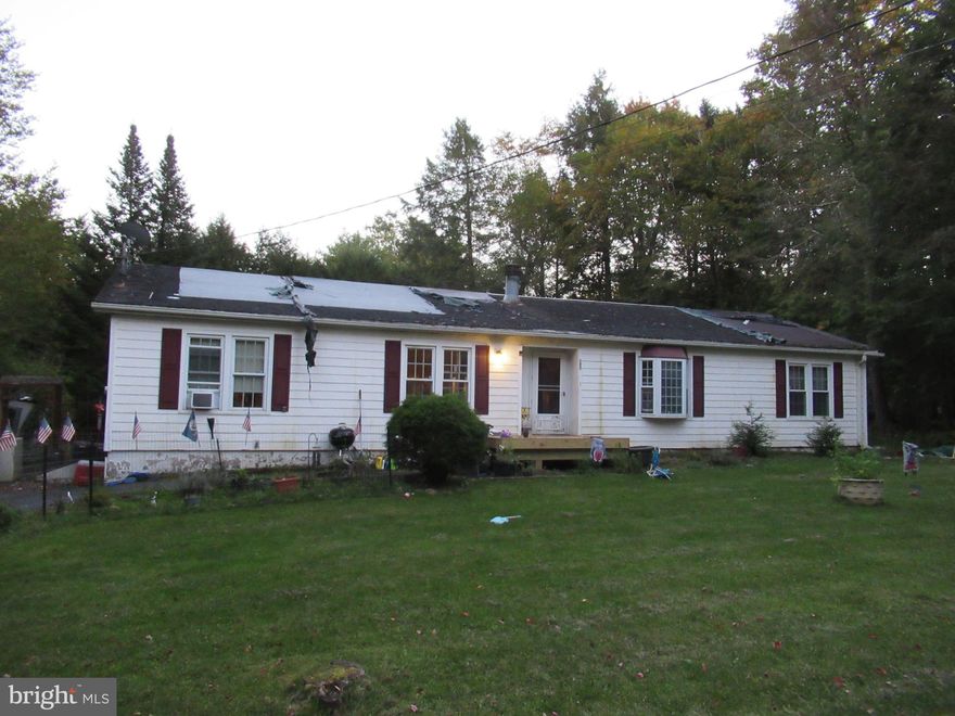 MULTIPLE OFFERS RECEIVED, FINAL AND BEST OFFERS DUE BY THURSDAY 5:00 P.M     ATTENTION HANDYMEN!! POCONO FIXER-UPPER AVAILABLE! This 3 bedroom, 2 bath home needs someone to bring it back to life! Existing features include 2 living rooms with a double-sided fireplace, primary bedroom with attached bath, eat-in kitchen, dining room, and great backyard. Tucked in a lake community in the Poconos! *Construction materials included-All items to replace the roof including-asphalt shingles, sheathing,10 sheets plywood, drip edge, ice and water sheild, nails. Lake community offers 2 lakes, playground, and shooting range. Close to all of the fun that the Poconos has to offer! No short-term rentals allowed in this community! **GATE CARD NEEDED TO ENTER COMMUNITY**