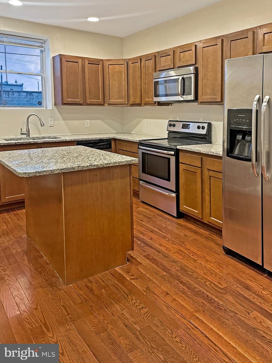 Step into this beautifully updated townhouse featuring gleaming hardwood floors, a spacious modern kitchen with ample kitchen cabinets for storage, island for food prep and entertainment. Open floor plan living and dining area with  expose brick wall. The basement is perfect for storage or future finishing in your own vision.  Media space for work at home or home school station. Primary  bedroom with personal bath and a his/her  closets. Nestled in a prime location with  lovely view of Transit ,and easy access to major roadways. This home is just minutes from vibrant local restaurants, cozy cafés, and lush parks — offering the perfect blend of comfort and community.