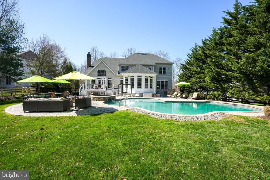 Discover your own slice of paradise w/ this meticulously updated Winchester Homes Belmont model home, featuring a captivating outdoor oasis. Nestled on just over half an acre, this residence embraces tranquility w/ lush trees encompassing the front & rear, complemented by meticulously designed landscaping that transforms the property into a private sanctuary, perfect for creating cherished moments w/ family & friends. Approaching the home, the combination of rich stone and brick, highlighted by a curved portico entry, welcomes you w/ warmth and elegance. Stepping inside, the grand circular staircase adorned w/ iron balusters catches the eye, & throughout the main level, gorgeous updated hardwood floors create an inviting atmosphere. The expansive living room seamlessly flows into the dining room, defined by lovely columns & exquisite trim details, offering a triple window to capture stunning views of the rear landscape. To the right of the foyer, a home office w/ French doors provides a quiet retreat for study & privacy. The kitchen, a focal point of seamless design, opens to the Great Room and Sunroom, creating an ideal flow for entertaining & daily living. The kitchen cabinets have been updated recently, professionally painted in a soft white, an oversized island, granite countertops, & newer stainless steel appliances showcase a harmonious blend of style and functionality. A built-in desk and spacious pantry & convenience, while the spacious opening over the kitchen sink area offers a prime view of the rear yard, pool, patio, and treehouse. The sunroom, with windows on three sides, becomes a delightful space to start the day w/ coffee or unwind in the evening w/ a glass of wine. Connecting to the deck and patio, it seamlessly extends the living space outdoors. The rear yard boasts a captivating Gunite pool by Anthony Pools, featuring an expansive tanning ledge, a large hot tub with a spillover ledge, mini jets creating a fountain-like atmosphere, and a custom paver patio for dining, lounging & entertaining. Inside, the two-story Great Room showcases a stone fireplace w/ a pellet stove insert, expansive windows capturing breathtaking views outdoors & a rear staircase leading to the upper level. The main-level laundry room off the kitchen adds practicality with a folding station and extra cabinets for pool towels. The upper level hosts the primary suite w/ tray ceiling, two spacious walk-in closets, a sitting area & a spa-like bath w/ upgraded tiles. Three additional bedrooms, one w/ its own full bath & a buddy bath shared by the other two bedrooms, as well as a spacious linen closets, complete this level. The lower level is an entertainment haven, featuring a home theatre w/ a new projector, a generous recreation room, rough in for a wet bar if desired in the future, two finished rooms suitable for dens/offices or overflow bedrooms & a full bath. A large, organized storage room & walk-up steps to the rear yard add convenience. A very spacious three car garage finishes off this great home & features plenty of room for additional storage. Beyond the enchanting features of this home, its location is unparalleled. Surrounded by a treed conservancy in the back & a tree save in front, it offers superb privacy and exceptional star-gazing at night. Lenah Run, w/ its Hamlet Style community, half-acre homesites, & natural conservancy, provides a serene living experience. Enjoy the community pool, Froggers Swim Team, various homeowners' events year round & convenient access to shopping, healthcare, library & schools. Embrace the nature inspired lifestyle in Lenah Run – you will love living here. Recently updated features; roof 5 years old, professionally painted kitchen cabinets, main HVAC replaced, all stainless steel appliances replaced, hardwood floors replaced on main level &Pellet wood stove added, new projector in media room, upper level carpet replaced.