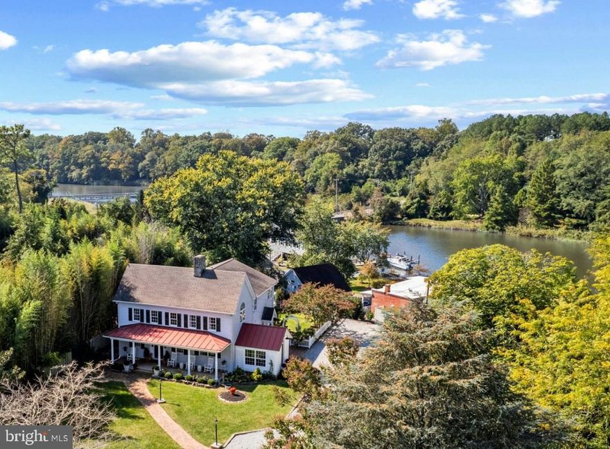 Built in 1880, this charming water-view Colonial farmhouse has been thoughtfully renovated to preserve its historic character while incorporating modern updates. From the moment you arrive, the home feels warm and inviting. Relax on the expansive front porch and take in the peaceful natural surroundings, including serene views of the Corsica River. Inside, water views continue to enhance the home’s timeless appeal. Gorgeous hardwood floors span both levels, while a striking double-sided brick fireplace serves as a natural centerpiece, elegantly defining the living and dining areas. The gourmet kitchen features quartz countertops, soft-close cabinetry, and flows seamlessly into the family room, creating an ideal space for everyday living and relaxing. Sliding doors lead to a brick patio and private backyard, perfect for gatherings and outdoor enjoyment.

The main level includes two bedrooms and a versatile bonus space, ideal for a home office with a view. The primary suite is a true retreat, showcasing vaulted ceilings, exposed beams, and a private deck with water views. A spacious dressing room and spa-inspired bath—complete with a freestanding soaking tub and large glass walk-in shower—enhance the sense of comfort and luxury.

Upstairs, you will also find an additional family area, a full bath, a dedicated laundry room, and a fourth bedroom with architectural details.

Located in the Historic Wharf area, just steps from Centreville Landing.  Enjoy access to a boat ramp, kayak launch, and nearby playground—offering a variety of outdoor and recreational opportunities.  No HOA.