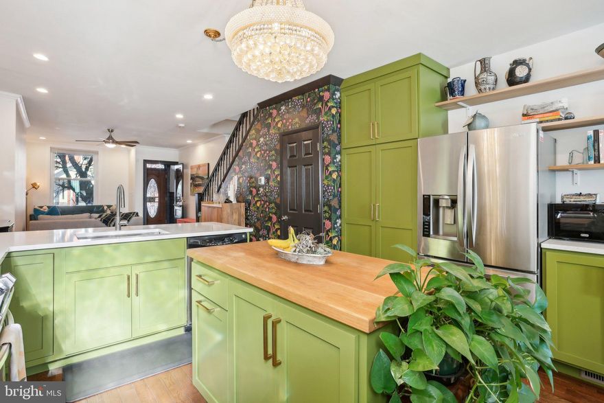 Back on the market. The buyer's financing fell through. Welcome to 3210 Clifford Street, a lovely 4-bedroom, 2-bathroom home for sale in Philadelphia, located in the Strawberry Mansion neighborhood. As you approach 3210 Clifford Street, the welcoming front porch sets the tone for what's inside. The cozy front porch is ideal for enjoying a morning coffee or catching up with neighbors. This well-maintained, updated, and move-in-ready gem combines classic row home charm with modern updates, including an in-law suite. Step inside and discover an open-concept first floor with living, dining, and kitchen areas that seamlessly blend contemporary design with classic elements. The hardwood floors and high ceilings create a spacious and airy atmosphere, making it an inviting space for relaxation and entertaining. The standout feature of the first floor is undoubtedly the designer kitchen, a space crafted for those who love to cook and entertain. This kitchen is a culinary delight, offering fashionable Green Cabinetry. Custom cabinets provide ample storage, blending style, and functionality. The sleek granite surfaces are perfect for meal preparation and add a touch of luxury. Ideal for food prep, and casual dining, the island features a butcher block countertop. Tiled Backsplash: A sophisticated backsplash adds visual interest and complements the overall design. This thoughtfully designed space is where family and friends will naturally gather, making it the heart of the home. Just past the kitchen, the dining area offers a spacious and inviting setting for meals with family or friends. Large enough to accommodate a sizable dining table, this space is perfect for hosting dinner parties and family gatherings. Beyond the dining area, the fenced backyard awaits, a versatile outdoor retreat. This space can be transformed to suit your needs, whether as a lush garden, a play area, or a spot for barbecues. The size of the yard offers the potential to convert it into off-street parking, a highly desirable feature in Philadelphia. The second floor features three well-proportioned bedrooms. The hardwood floors continue throughout, enhancing the natural light that pours in from large windows. The front bedroom is the primary bedroom and features a gorgeous mantle. The middle bedroom is the smallest but it's a perfect guest room or home office. The back bedroom is set up as a Den but this versatile space can easily be a bedroom or home office. Each bedroom offers ample closet space, providing plenty of room for storage. The hall bathroom features a full-size tub and single-sink vanity. Third-Floor In-Law Suite: A unique feature of this property is the third-floor in-law suite, offering a self-contained space that can serve multiple purposes. Whether you need a private area for guests or extended family, this suite is equipped to meet your needs. Key Features of the In-Law Suite: Separate Electricity: Independent electrical system for added convenience. Full Bathroom: A private bathroom with modern fixtures. Spacious Layout: Ample space for a bed, seating area, and even a kitchenette. This versatile suite can function as a mini-apartment, providing privacy and flexibility that is rarely found in similar homes. Located steps away from Fairmount Park, one of the largest urban parks in the U.S. This neighborhood is known for its tree-lined streets, beautiful architecture, and proximity to Fairmount Park. Here, you can enjoy a variety of outdoor activities, from hiking and biking to walks along the Schuylkill River on Kelly Drive. Local Attractions Include Le Cat Café: Enjoy coffee while interacting with adoptable cats, a unique local experience. Strawberry Green Driving Range: Practice your Golf Swing. Otto’s Taproom & Grille: A popular spot for craft beers and casual dining. You will not have to go very far for groceries, eateries, and night life. The neighborhood is also well-connected, with easy access to public trans