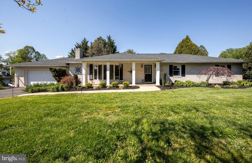 Welcome to this beautifully maintained, solid brick rancher nestled in the sought-after Orchard Lakes community. Set on approximately one acre of lush, professionally landscaped grounds, this home offers a private, park-like retreat bursting with color and charm. Step inside to an inviting open layout of over 3,200 square feet of living space highlighted by a spacious living room filled with natural light from a stunning oversized bay window. The spacious, updated kitchen is both stylish and functional, featuring exposed wood beam ceilings, granite countertops, a breakfast bar, recessed lighting, stainless steel appliances, and a new dishwasher. A separate formal dining room showcases gleaming wood floors and updated lighting. The generously sized bedrooms offer comfort and convenience, each equipped with ceiling fans. Updated bathrooms showcase ceramic tile flooring and showers. The walkout lower level significantly expands your living space with a massive recreation room—perfect for entertaining—complete with a bar area, fireplace, and a toasty and economical pellet stove. Three panel French door leads you to a gorgeous outdoor oasis. Unwind in the hot tub on the beautiful flagstone patio while enjoying views of your serene backyard that backs to woods and a stream. The lower level also includes an updated full bathroom with a new vanity, potential fourth bedroom, abundant storage spaces with shelving, and a large laundry room featuring a new washer & dryer and double utility sink. Major updates provide peace of mind, including roof (2017), windows (2025), hot water heater (2024), HVAC system (2021), and exterior landscape lighting (2025). This exceptional property offers the perfect blend of comfort, style, and tranquility—ready to become your new home.