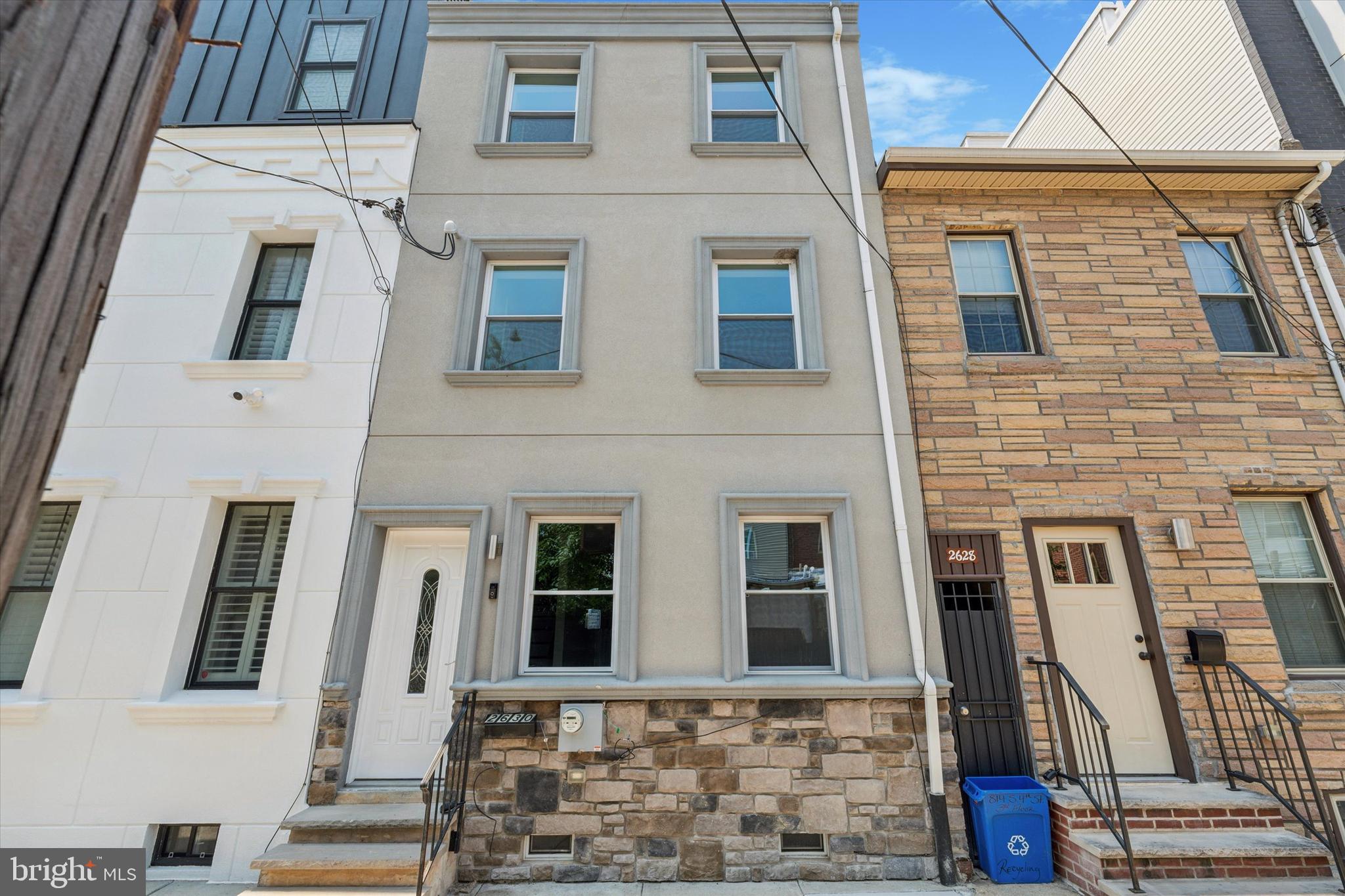 This beautifully renovated 3-story, 4-bedroom, 2.5-bathroom townhome offers modern living with thoughtful design throughout. Step inside to find gleaming birch cherry hardwood floors, recessed lighting, and an open-concept first floor that’s made for entertaining. The wide living room flows into a generous dining area and a sleek, updated kitchen complete with granite countertops, a center island with breakfast bar, stainless steel appliances, and direct access to a spacious backyard, ideal for summer grilling or an evening under the stars. A stylish powder room completes the first floor. On the second level, you'll find two well-sized bedrooms and a stunning hall bath featuring dual vanities, porcelain tile, and a tiled tub/shower combo. The third floor is a true primary suite retreat, boasting a rear bonus room (perfect as an office, nursery, or walk-in closet), a large primary bedroom, and a spa-like ensuite bathroom with dual sinks, modern porcelain finishes, and a glass-enclosed oversized shower. With ample storage throughout, natural light pouring in, and finishes that blend comfort with sophistication, 2630 E Harold Street is ready to welcome you home. Nestled just minutes from I-95 and steps from local favorites like Wawa, Dunkin’, Planet Fitness, and the vibrant York Street and Fishtown scene, this home places you at the intersection of convenience and community.