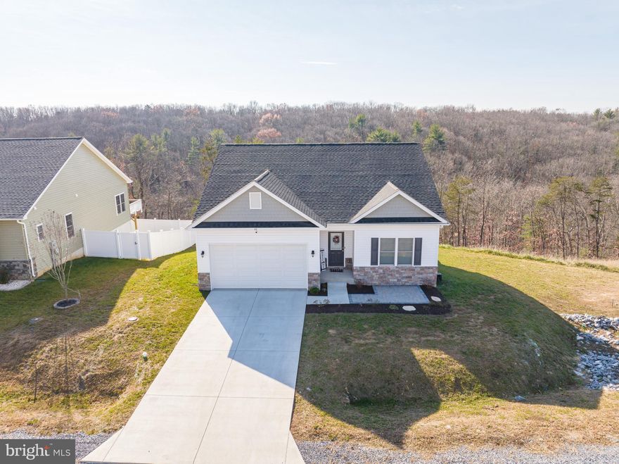 Why wait for new construction?! Raised rancher only 1 year old.  Welcome to 42 Larimar Lane featuring spacious 3 bd/2 ba open concept living, 9ft ceilings and luxury vinyl plank throughout main areas. Kitchen offers quartz countertops, stainless steel appliances and island with eat-in area. Family room right off kitchen is great for entertaining! Direct access to back deck. Primary bedroom has walk-in closet and en suite bath with dual vanity and custom tiled shower. Two secondary bedrooms share a full hall bath. Full lower level walk out to backyard is ready for your finishing touches. Exterior has professional landscaping and combination vinyl and stone veneer. Phenomenal mountain views from the deck. Water softener system and alarm system will transfer with the home.