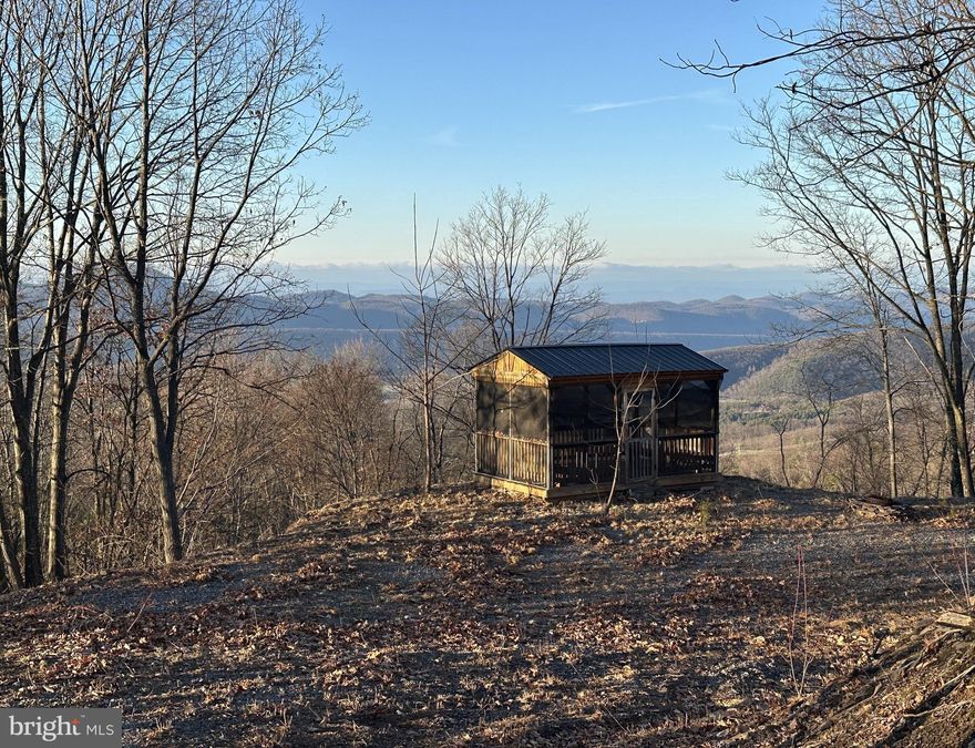BIG WOODS.....BIGGER VIEW.....BIGGEST VALUE....NEARLY 43 ACRES ON TOP OF THE WORLD WITH 180 DEGREE VIEWS FROM EAST TO NORTH TO WEST.....ELEVATED AT 2500 FT WHERE THE COOL WINDS BLOW. DRIVEWAY INSTALLED TO BUILD/CAMP SITE WITH SCREENED GAZEBO.....15K WORTH OF INFRASTRUCTURE ALREADY IN PLACE. WIDE BACKBONE RIDGE RUNS THE LENGTH OF THE PROPERTY WITH RAVINES ON EITHER SIDE OFFERING PROTECTION FROM CLOSE NEIGHBORS.....OLD LOGGING ROADS MAKE THIS PROPERTY WAY MORE USABLE THAN YOU COULD IMAGINE. OLD GROWTH CHESTNUT OAKS AND MOUNTAIN LAUREL LANDSCAPE.....YOU CAN'T HIDE FROM THE "ON THE MOUNTAIN FEELING" THIS PROPERTY EXUDES. WORTHY OF A TROPHY CABIN OR FULL TIME HOME.....THE VIEWS ARE INSANE....MOUNTAINS TO THE NORTH AND OVERLOOK MOOREFIELD AND THE SOUTH BRANCH VALLEY TO THE WEST. TROPHY BUCKS & BEAR ARE HERE FOR THE HUNTER.... LOCATED IN THE PRESTIGIOUS 10,000 ACRE GATED COMMUNITY ASHTON WOODS, A ONE OF A KIND PLACE, WHERE YOU CAN ESCAPE THE WORK & WORRY OF THE BIG CITY AND TICKLE ALL YOUR OUTDOOR FANCIES....15 MINUTES OFF 4 LANE SUPER HIGHWAY, 15 MINUTES FROM MULTIPLE PUBLIC ACCESS POINTS ON THE SOUTH BRANCH OF THE POTOMAC RIVER, 15 MINUTES FROM MOOREFIELD, 45 MINUTES FROM SKI RESORTS, 10 MINUTES FROM PRIVATE COMMUNITY ACCESS TO NATHANIEL MOUNTAIN WILDLIFE MANAGEMENT AREA 10,000 ACRES OF PUBLIC HUNTING & HIKING.....IF YOU LIKE THE OUTDOORS, YOU'LL NEVER RUN OUT OF THINGS TO DO.....WHO KNEW? ALL OF THIS WITHIN 2 HOURS OF DC.....BELIEVE IT! A DECENT 20 ACRE LOT IN ASHTON WOODS STARTS AT 125K, YOU'RE GETTING AN ADDITIONAL 23 ACRES FOR AN EXTRA 50K....THAT MATH IS EASY....THIS ONES A NO BRAINER, NO REASON TO OVERTHINK THIS ONE, COME GET THE DEAL!