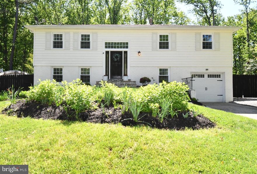 This is a must see! Gorgeous, Remodeled Home in Lake Ridge! This home features 4 bedrooms and 2.5 bathrooms. Luxurious flooring on the main level, spacious remodeled kitchen with granite countertops and modern stainless-steel appliances. Large living room open to the dining room, 2 remodeled full baths, primary bedroom with primary full bath, and 2 good size bedrooms.  
Lower level features a large family room filled with natural light where you can cozy up to the wood burning stove in the evening or enjoy a movie night. In addition, there is a bedroom or office, half bath, and laundry room. Centrally located to Fort Belvoir and Quantico.  Easy access commuter lots, Prince William Parkway, and I95.