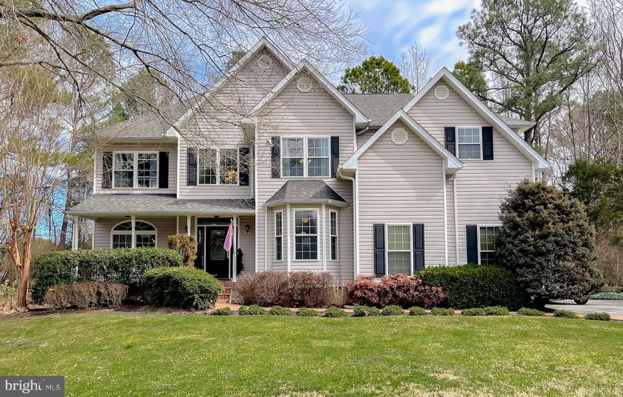 Presented is your chance to own property in the highly desirable Breton Bay Golf Community of Leonardtown. Here you'll enjoy stunning views of the beautiful golf course and the perks of living in a waterfront community with a nearby marina and access to a private beach area of the Bay!  Situated on a small, quiet cul-de-sac street located directly across from the golf course. This level lot spans almost an acre, inviting you to sit back and relax on your front porch. As you step through the front door, you'll be greeted by the double-height ceilings and an Elegant staircase. A private office space, large enough to accommodate an executive desk, enclosed with glass French doors—creating the perfect setting for a quiet home office. Continuing down the hallway, you'll discover the open-concept living room, featuring 18-foot ceilings and expansive window space with picture windows that provide an abundance of natural daytime lighting. The living room features a gas fireplace, providing a comfortable environment that can accommodate a sectional sofa of any size. Transitioning into the gourmet kitchen, one will find an array of high-end matching Wolf brand stainless steel appliances. Built-in countertop gas cook range, double wall ovens, and steam option microwave. The refrigerator is a  brand-new KitchenAid.  Elegantly appointed cream-colored raised panel custom cabinetry, a spacious center island, granite countertops, and a decorative tiled backsplash. Additionally, the kitchen incorporates a breakfast nook that can accommodate a full-size dining table. The main floor further includes a separate formal living room and dining room, as well as an impressive full-size bar area. This bar features an additional refrigerator, ceiling-height shelving, and bar countertops that can comfortably accommodate four barstools. The sizable back deck is constructed from composite decking material— The custom-built deck is enhanced with solar pillar lighting, making it an ideal space for patio furniture and enjoyment of the private backyard. On the upper level, the expansive owner's suite presents a walk-in closet equipped with built-in shelving and countertops. The ensuite bathroom was modernly remodeled, featuring a tiled alcove Whirlpool bathtub, a beautifully tiled walk-in shower with built-in wall shelves, and a bench. Create a neat space with his and her sinks and the ceiling-height built-in cabinetry. The upper floor accommodates a total of four bedrooms. The hallway bathroom has also been updated offering new vanities, flooring, and a walk-in tiled shower equipped with modern fixtures. An additional full bathroom is located in one of the bedrooms. The property includes an interior-access basement featuring three large separate areas. The HVAC system and tankless hot water tank were replaced two years ago. With no HOA, you still have the option to join the Breton Bay Golf and Country Club, which features a competition-sized pool with a separate diving area, and tennis courts. An open house is scheduled for Sunday the 16th, from 3 to 4 PM.