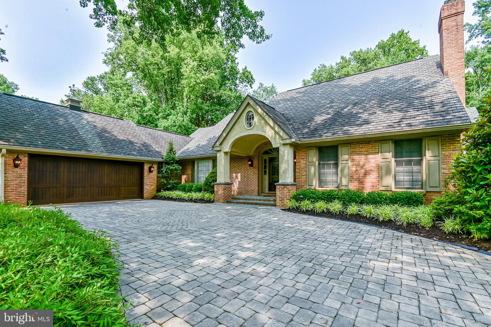 Located in the tucked away community of Fairthorne, along Barley Mill Road between Centerville Road and Centre Road/Route141 in 19807 is a re-imagined custom retreat providing over eight-thousand square feet of finished living space. Positioned with quiet composure on a picturesque cul-de-sac, the exterior of this home offers a striking mix of steadfast architectural design juxtaposed with a stimulating assortment of mature-growth evergreen and varied deciduous trees. This enchanting assemblage of distinctive residences, located just outside the Wilmington city limits, is truly an island in the center of it all—yet minutes from the area’s vibrant and eclectic dining, shopping, and entertainment destinations. This property’s “notable neighbors” include Valley Garden Park, Hoopes Reservoir, Mt. Cuba Center, Winterthur and Hagley Museum. A key benefit of this home’s location is its proximity to the recently opened Wegmans at Barley Mill, only 1.5 miles door-to-door! Your first impression of this Cape Cod-style home is enhanced by the substantial grassy frontage and mature landscaping, the circular paver driveway, carriage-house wall-mounted light fixtures flanking the oversized two-car garage, and the thoughtful way the owners applied a hint of French-country graciousness to the overall design. Immediate features include a handsome wrap-around brick façade, an eye-catching portico with a center oculus above a step-up, flagstone-covered stoop, and a transitional roofline topped with striking architectural shingles. In 2005, the owners embarked on a major rebuild of the original house. The result is a breathtaking, twenty-first-century marvel with a seemingly endless sea of front-to-back hardwood flooring, an inescapable application of expert millwork including layered chair rails and crown molding, arched and straight casings, coffered and tray ceilings, and sumptuous wainscoting, and confidently chosen wall colors setting the mood of this home. The skillful use of space, reflected in the dynamic layout, translates well to the needs of a contemporary lifestyle. Main-level highlights include the foyer-facing formal living room with fireplace and the equally elegant foyer-facing formal dining room, a spectacular eat-in kitchen filled with all the expected features and French-door access to the expansive wrap-around flagstone patio, a luxurious primary suite with an oversized custom walk-in closet, an open library with custom built-ins and a fireplace, an adjoining family room with built-in cabinet, a private home office with two desk areas and built-ins, a powder room, and a combination laundry and mudroom with exterior access. The upper-level benefits of this terrific home include three secondary bedrooms each with a walk-in closet, ample additional hallway storage and two hall baths. The open walk-out lower-level features a home theater room, a sitting area, a wine storage room, a full-size slate pool table, an exercise area, a large wet bar, a full bathroom with a walk-in stall shower, direct access to a private patio, and a step-down Golf Room...deep enough for a full swing in the netted driving area. WOW! Additional benefits include three-zone HVAC, a central vacuum, landscape lighting, an irrigation system in the yard, recessed lighting, dimmers throughout, ample storage space and closets, and custom cabinets throughout. Private, beautiful, serene. Welcome Home! Seller is a licensed real estate broker in the state of Delaware.