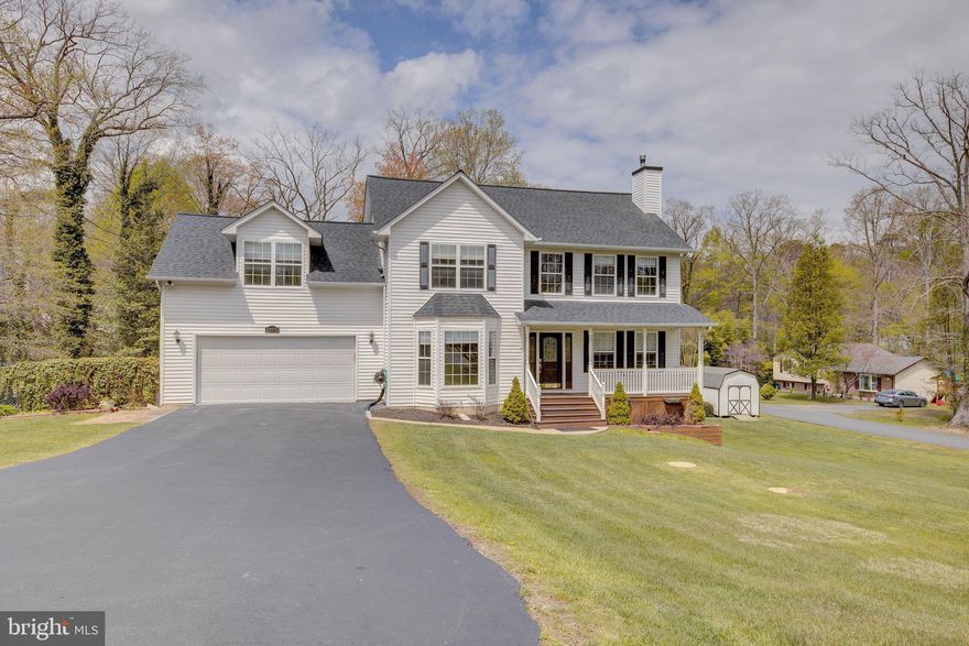 This captivating Colonial has all of the curb appeal and space you could want perfectly sited on an expansive double corner lot.  The front porch welcomes you into the grand entry on the main level.  Your first glance guides you up the impressive custom staircase lined with solid wood handrails and wrought iron spindles. The soaring ceiling and large windows provide an airy feel filled with natural light.  The entry is flanked by a dining area and study.  The recently remodeled kitchen features gorgeous granite countertops, stainless steel appliances, custom cabinetry with wine rack, sizable pantry, and center island with breakfast bar seating. The kitchen flows beautifully into the large living room.  After a full day make your way up to the large Primary Suite featuring a walk-in closet, cathedral ceiling, and relaxing en-suite bathroom with soaker tub and separate water closet.  Down the hall you have convenient laundry, a full bathroom, and three generously sized bedrooms including one that could be a second Primary or Guest Suite.  All four bedrooms are lined with brand new plush carpet.  New and upgraded light fixtures, ceiling fans, and hardware are featured throughout the home.  If three thousand square feet is not enough, there is another thousand in the lower level ready to make your own featuring rough-in plumbing for a bathroom and an eight foot sliding walkout glass door.  The outdoor spaces of this home are amazing including the large screened-in porch and deck that overlook the backyard. The expansive double corner lot has been beautifully landscaped with Crape Myrtles, Japanese Maples, Alberta Spruces, Weeping Cherry, and Bradford Pears to name a few.  The oversized garage easily fits two larger vehicles and still has room for storage.  In addition to garage parking, the large paved driveway includes an extra parking pad area.  The large shed offers extra storage space.  The roof was replaced in 2018.  This community offers plenty of amenities including two beaches, lake, clubhouse, and playgrounds.  The location is convenient to shopping, restaurants, Solomons Island, and Patuxent River Naval Air Station.