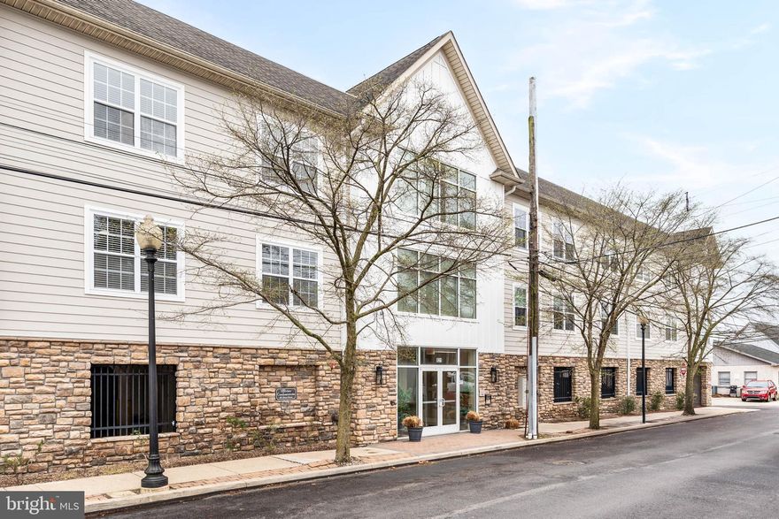 This stylish corner unit condo is a fantastic opportunity in the heart of Conshohocken Borough, just a short walk to everything Conshohocken has to offer, including popular restaurants, nightlife, and scenic walking trails. With its desirable corner location, the home enjoys added privacy and an abundance of natural light throughout. Inside, you’ll appreciate the spacious open floor plan designed for comfortable everyday living. The large great room flows seamlessly into a well-appointed kitchen featuring granite countertops, stainless steel appliances, and a convenient breakfast bar, perfect for casual meals or entertaining. A large picture window enhances the space and fills the home with natural light. The primary bedroom offers a spacious walk-in closet and a private bath complete with tile flooring, a granite-topped vanity, and a tub/shower combination with modern, black-framed glass shower doors. A sizable secondary bedroom is served by an additional full bath, providing flexibility for guests, family, or a home office. A dedicated laundry area adds everyday convenience.  This secure 12-unit building features-controlled entry and elevator access, and the unit includes two parking spaces, an added bonus in this desirable location. Ideally situated with easy access to Routes 76 and 476 and public transportation, this home offers both comfort and convenience.
Don’t miss the chance to own this bright and beautifully positioned corner unit condo!