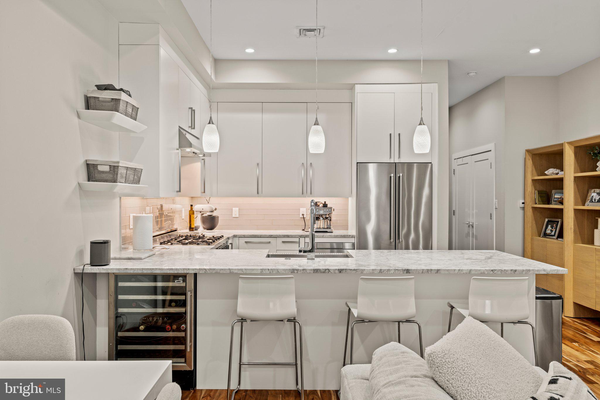 HUGE PRICE REDUCTION! Motivated sellers- A modern and elegant residence nestled in the heart of Northern Liberties. This exquisite home offers a perfect blend of contemporary design and luxurious amenities, providing an unparalleled living experience. Spanning 2,000 square feet, this multi level 2 bed, 2.5 bath with ONE CAR COVERED CARPORT parking -home is thoughtfully designed to maximize space and comfort. The wide open kitchen is a culinary enthusiast's dream, featuring top-of-the-line appliances, including a range and wine cooler, ideal for entertaining or enjoying intimate meals at home. The primary suite is a true retreat, boasting a Juliet balcony that invites natural light, fresh air and a skyline view that can’t be beat. The en-suite bathroom is a haven of relaxation, complete with heated flooring for those chilly mornings. The additional bedroom and bathroom offer ample space for guests or a home office. Step outside to discover the expansive roof deck, where panoramic views of the city skyline create a breathtaking backdrop for gatherings or quiet evenings under the stars. The deck, along with a private basement with powder room, adds to the home's allure, providing versatile spaces for leisure and storage.
Additional features include one-car covered parking space, ensuring convenience in this prime location. Tucked within a pocket of some of the best culinary experiences the city has to offer. One Shot Coffee, Cafe LaMaude, Honey’s Sit-n-Eat, North 3rd, El Camino Real and just a short walk to booming Frankford Avenue in Fishtown. Discover the perfect blend of elegance, convenience and modernity at 1103 North Galloway Street, where every detail is designed to elevate your lifestyle.