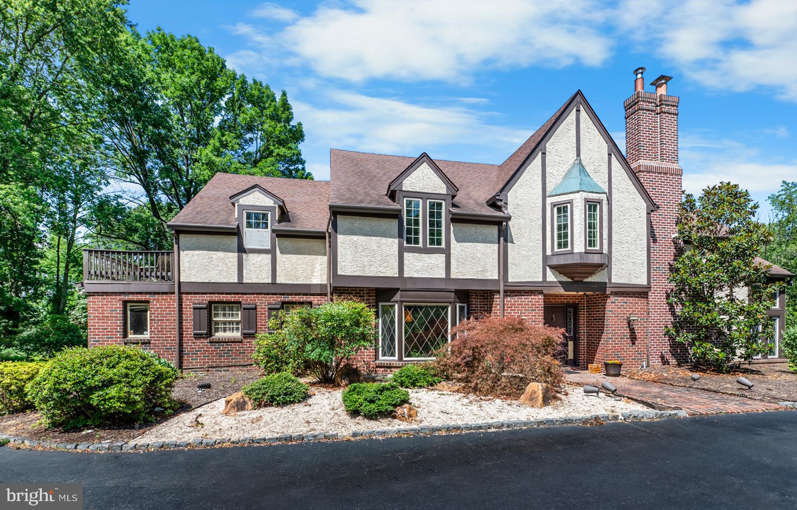 Experience the allure of this distinctive English Tudor, situated on over an acre of land and directly across from a tranquil nature preserve. This home exudes character and natural light, beginning with a grand foyer and exquisite oak floors enhanced by mahogany inlays. The gourmet kitchen boasts a large center island, tile flooring, granite countertops, custom cabinetry, a deep sink, and an incredible reverse osmosis purification system.
Expansive doorways open to a formal dining room with hardwood floors and a charming bay window. The impressive living room features soaring two-story ceilings, artistic stained glass windows, and a cozy wood-burning fireplace. The inviting family room offers a pellet stove, exposed beams, and a slider leading to the back patio.
The main level also includes a practical powder room, a laundry room, and an oversized two-car garage. On the upper level, the master bedroom serves as a luxurious retreat with a dressing room that includes three closets and an en-suite bathroom with granite countertops, heated floors, custom Indonesian teak cabinets, and a walk-in shower. Additionally, this level features three more bedrooms and a full bath with a jetted tub.
The partially finished basement provides additional living space and includes a wet bar. This remarkable home seamlessly blends elegance and comfort, presenting a truly rare opportunity. Pre-inspection report available for peace of mind.