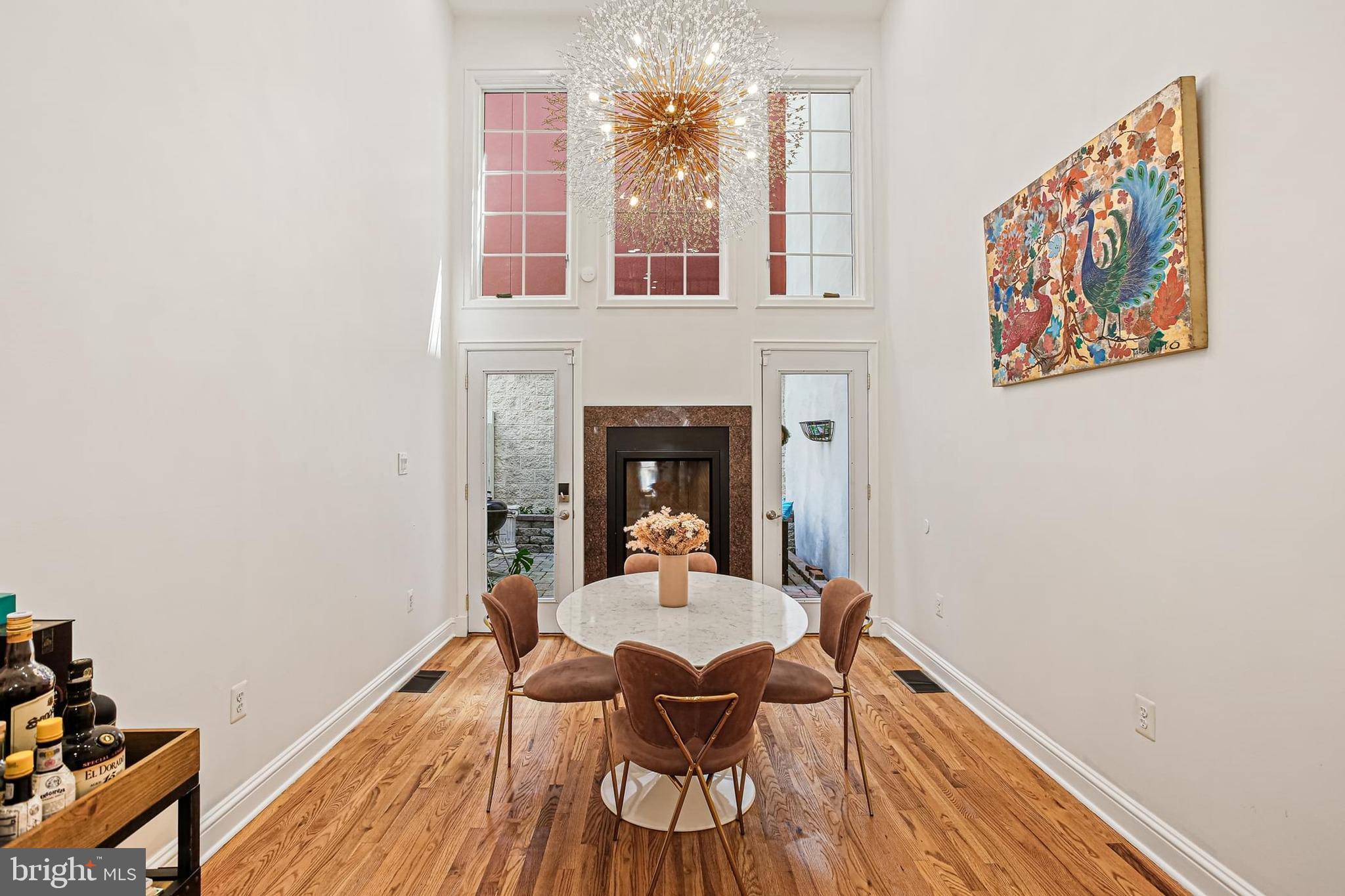 Experience sophisticated city living in this beautifully updated colonial just steps from Baltimore Inner Harbor. This just renovated brick-front home blends timeless architecture with modern luxury across three spacious levels.
Inside, you'll be greeted by rich hardwood floors, soaring ceilings, elegant crown molding, and recessed lighting; creating a refined yet inviting atmosphere. The grand living room flows seamlessly into the gourmet kitchen, a chef’s dream with high-end stainless steel appliances, dual sinks, granite countertops, and generous storage.
The dramatic dining area is a showstopper, featuring a striking two-story ceiling, sun-filled picture windows, and a cozy gas fireplace. From here, step out to the rear patio for effortless indoor-outdoor entertaining.
Upstairs leads to a stylish loft that overlooks the dining room below. Enjoy your second-level guest suite including and spa-inspired dual-entry bath with double vanities and a luxurious walk-in shower.
The third floor offers a private retreat with exposed brick accent wall, a seperate dedicated office space, hall bathroom with a recently refinished claw-foot tub, and access to a rooftop deck with breathtaking panoramic views of the city skyline.
Located minutes from premium shops, gourmet dining, and top-tier entertainment—with easy access to I-695, I-83, and I-95—this stunning home delivers urban convenience and upscale comfort in one of the city’s most desirable locations.
Call for a showing today!
