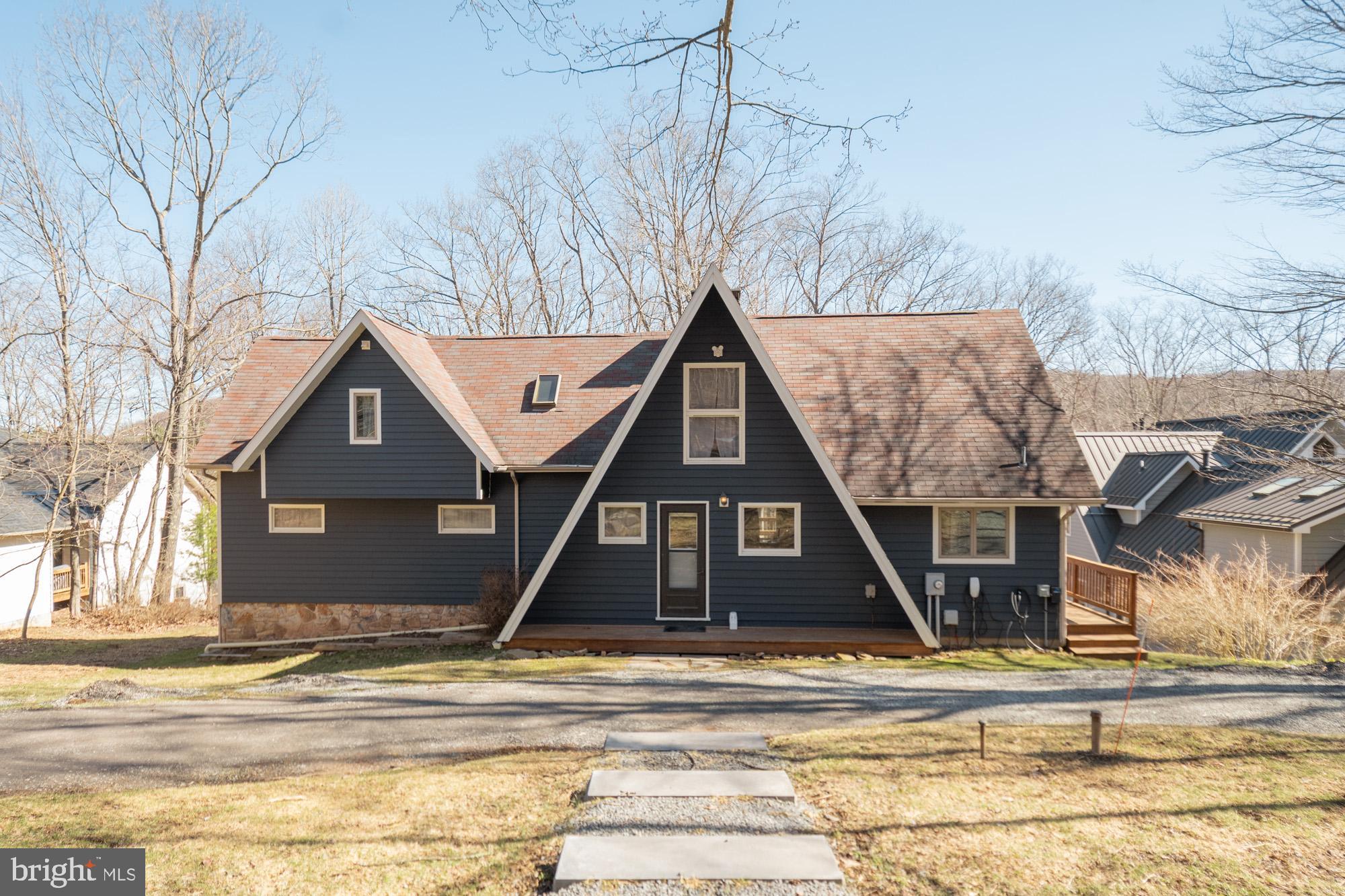 5BR, 3BA lakefront home with a private Type A dock, 1 mile to Wisp! Coveted location on Marsh Hill Rd, you will love 104 ft of wooded waterfront privacy and .63 acres of land. Gently sloped lot with a deep water dock area which offers maximum usage through the entire boating season. This renovated A frame is the perfect blend of vintage Deep Creek with some modern touches. MASSIVE stone fireplace in the living room with vaulted ceilings and exposed beams sure to be a favorite spot overlooking the lake -impressive views and no lack of natural lighting. Unique floor plan, large rec room area on the lower level with walk out to the lake. Spacious wrap-around deck for entertaining and outdoor dining is also a perfect spot for your hot tub with lake views. Extensive hardscaping and parking area added recently, along with a convenient circular driveway. Licensed vacation rental, A Frame of Mind.