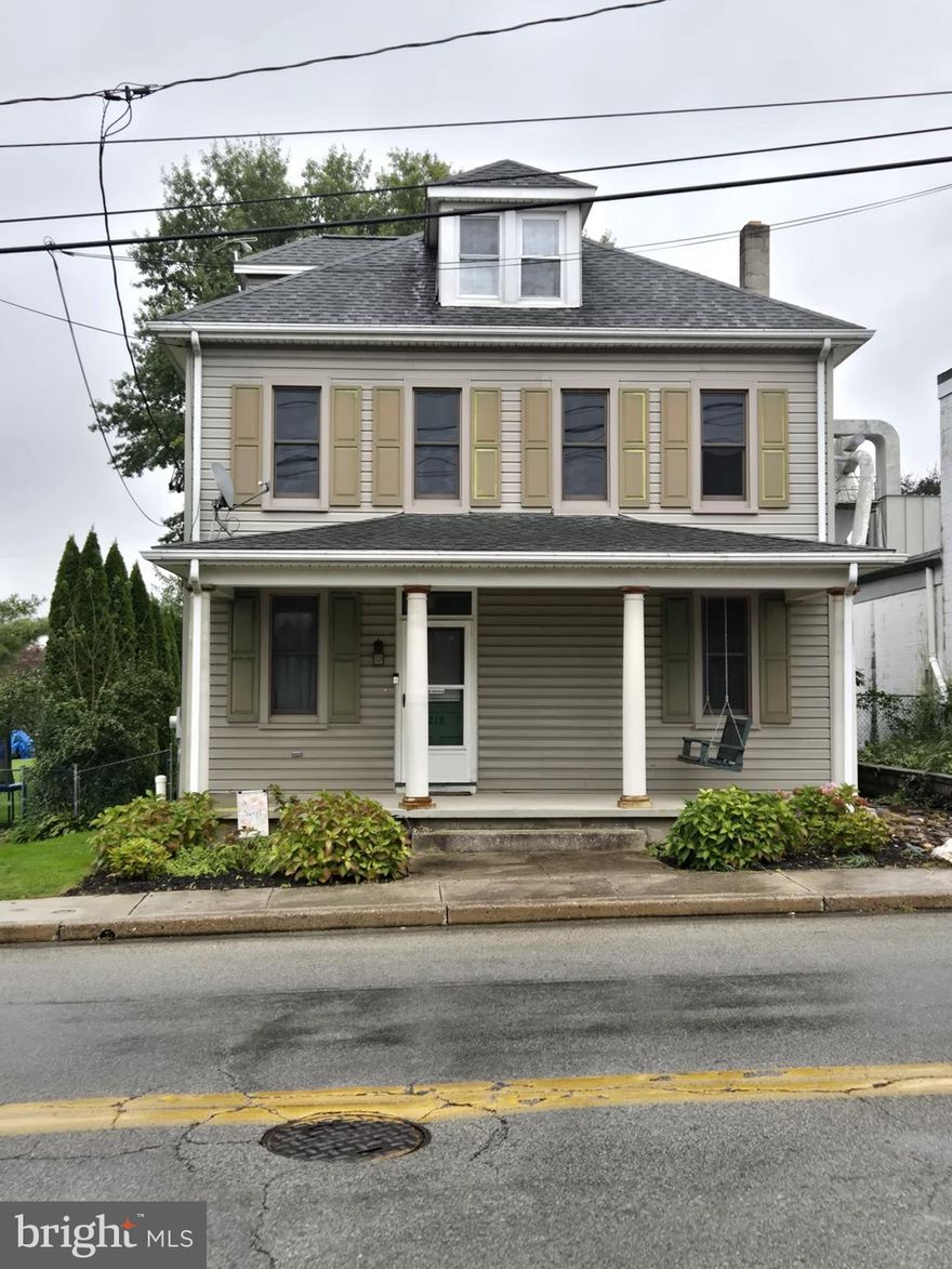 Situated on the outskirts of town, this charming Colonial showcases a large front porch, four bedrooms and plenty of appealing features. In addition to its 4 bedrooms and 1.5 bathrooms, the home offers hardwood flooring throughout, stainless steel appliances, crown molding, updated windows, a newer roof, wood stove, full basement, and a walk-up attic for extra storage or living space. 
The exterior has a rear porch, fenced yard, and detached garage, providing both off-street and on-street parking options for added convenience. These outdoor amenities enhance the home's appeal, making it ideal for relaxing, entertaining, and everyday living.