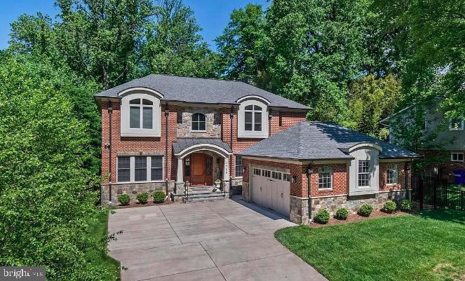 This exceptional custom-built estate in Burning Tree Valley is a true testament to refined living, offering an exquisite blend of elegance, comfort, and craftsmanship. Carefully selected by a Feng Shui expert, this remarkable residence boasts an elegant natural stone and brick façade, an oversized TWO-car garage with 4 additional driveway spaces, and two luxurious primary suites—one on the main level and another on the upper level for ultimate convenience. With a total of 5 bedrooms, 5.5 bathrooms, and 6,491 square feet of impeccably designed interiors, every detail has been carefully curated.
Step through the custom-designed Mahogany front door, and a breathtaking two-story foyer welcomes you with gleaming marble floors, and a crystal chandelier. The formal dining room showcases an exquisite crystal chandelier, adding a touch of refined elegance. A gourmet chef’s kitchen serves as the heart of the home, featuring a granite and marble island with bar seating, top-of-the-line Subzero-Wolf appliances, custom cabinetry, and a stylish butler’s pantry. The adjacent family room, anchored by a gas fireplace and a wall of windows, creates a warm and inviting atmosphere. A convenient powder room and a well-designed mudroom lead to the extra-large garage with abundant storage and functionality. The main-level primary suite features an elegant tray ceiling, and a spacious walk-in closet. The ensuite spa bath boasts custom tile work, premium finishes, a Jacuzzi soaking tub, and an oversized multi-head shower.
The upper-level primary suite exudes elegance, complete with a private sitting room entry, soaring tray ceilings, and a dramatic floor-to-ceiling window overlooking the lush rear garden. The ensuite bathroom is a spa-like escape, featuring a 2-person Jacuzzi soaking tub, dual vanities, and a steam shower with custom tile and multiple shower heads. Two additional bedroom suites, each with walk-in closets and private baths, provide both comfort and style. A convenient bedroom-level laundry room is equipped with a large-capacity washer and dryer, a large sink, and ample storage shelves.
The lower level, with its 9-foot ceilings and full-size windows, offers a vast recreation room with a wet bar, a fifth bedroom with a full bath, and a dedicated fitness studio. Additional amenities include a wine room, a second laundry room, and abundant storage space.
This home showcases superior craftsmanship, from its 2x6 framing and soaring 10-foot ceilings on the main level to the custom millwork, solid core interior doors, and meticulous architectural detailing.
Beyond its interiors, the professionally landscaped backyard offers an outdoor oasis. Terraced garden retaining walls, mature trees, and lush greenery frame the multi-level flagstone patio, complete with a built-in gas line.
Perfectly located in one of the most sought-after neighborhoods in the DMV, this home provides seamless access to Whitman High School, Burning Tree Elementary, Pyle Middle School, Beech Tree Park, Downtown Bethesda, and major transportation routes. A rare blend of timeless elegance, masterful design, and modern luxury, this estate redefines sophisticated living.