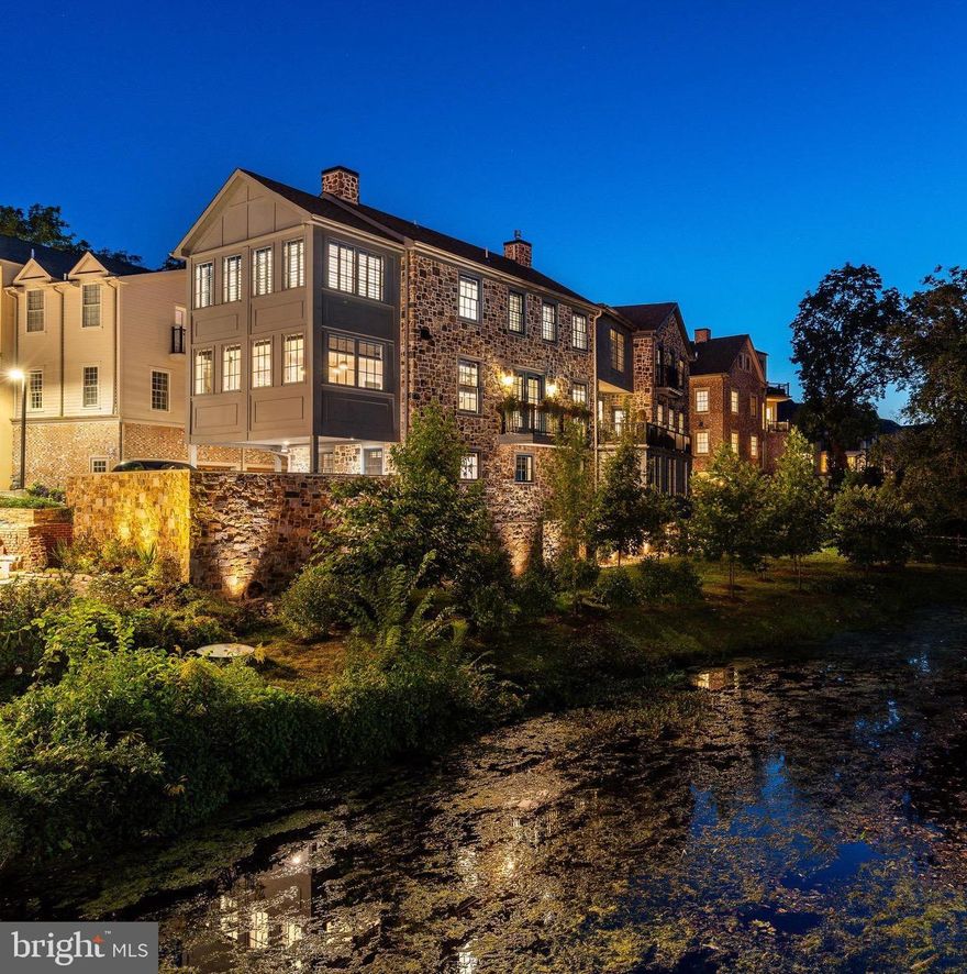 Introducing The Falls at New Hope. 2023 Excellence Award Winner: A Masterpiece of Luxury Living. Discover unparalleled elegance and serenity at 18 W. Mechanic Street, Unit FIVE, an extraordinary residence within The Falls at New Hope, an award-winning luxury townhome community designed by Ralph C Fey Architects, AIA. Nestled along the Aquetong Creek and New Hope's historic canal path, this exclusive corner unit offers unobstructed water views and a seamless connection to nature, just steps from the vibrant heart of New Hope Borough. From the moment you enter, this custom-built, three-level townhome stuns with architectural precision and sophisticated design. The private entrance welcomes you with radiant natural light, a sleek gas fireplace, elevator access to all floors, and an oversized two-car garage complete with custom built-ins for optimal storage. Every detail was thoughtfully curated to elevate daily living to an art form. The home is also equipped with a whole-house generator for comfort and security in any season. The second floor is a showcase of contemporary elegance, featuring white oak hardwood floors, custom lighting by Design Within Reach, and a spacious open-concept layout that effortlessly flows between the living, dining, and gourmet kitchen areas. The chef’s kitchen is a statement in style and function with custom Elmwood cabinetry, Mikado Quartz and leathered Calcutta countertops, stainless steel appliances, and an expansive island perfect for entertaining. A built-in wet bar with wine fridge and sink adds a touch of refined hospitality. French doors open to your private balcony, complete with custom planters and irrigation system, an idyllic perch to enjoy golden hour over the water. At the heart of the home, a stunning architectural showpiece awaits: a dramatic floating staircase with black metal stringers and open risers, offering a striking contrast to the warm wood tones throughout. Both sculptural and functional, this statement piece anchors the modern aesthetic and connects each level with elegance and grace. The upper level features two bedroom suites, including a luxurious primary retreat with a spa-inspired bath, floating double vanity, steam shower, and a deep soaking tub designed for relaxation. A dedicated laundry area adds ease and practicality, while a second suite with a built-in Murphy bed offers flexibility for guests or workspace. This is more than a home, it’s a lifestyle. Enjoy the perfect blend of history and modernity, nature and culture, just moments from the Bucks County Playhouse, fine dining, boutique shopping, and year-round events that have made New Hope one of the most celebrated small towns in America. Don't miss the rare opportunity to own at The Falls at New Hope where luxury, location, and architectural excellence converge to create a truly unforgettable living experience.